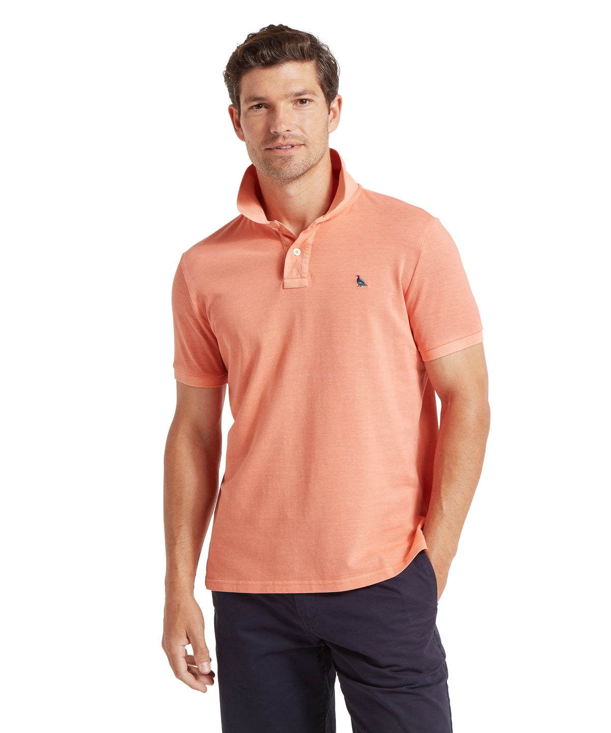 Coral peach short-sleeved St Ives garment dyed polo shirt with small embroidered logo on left chest