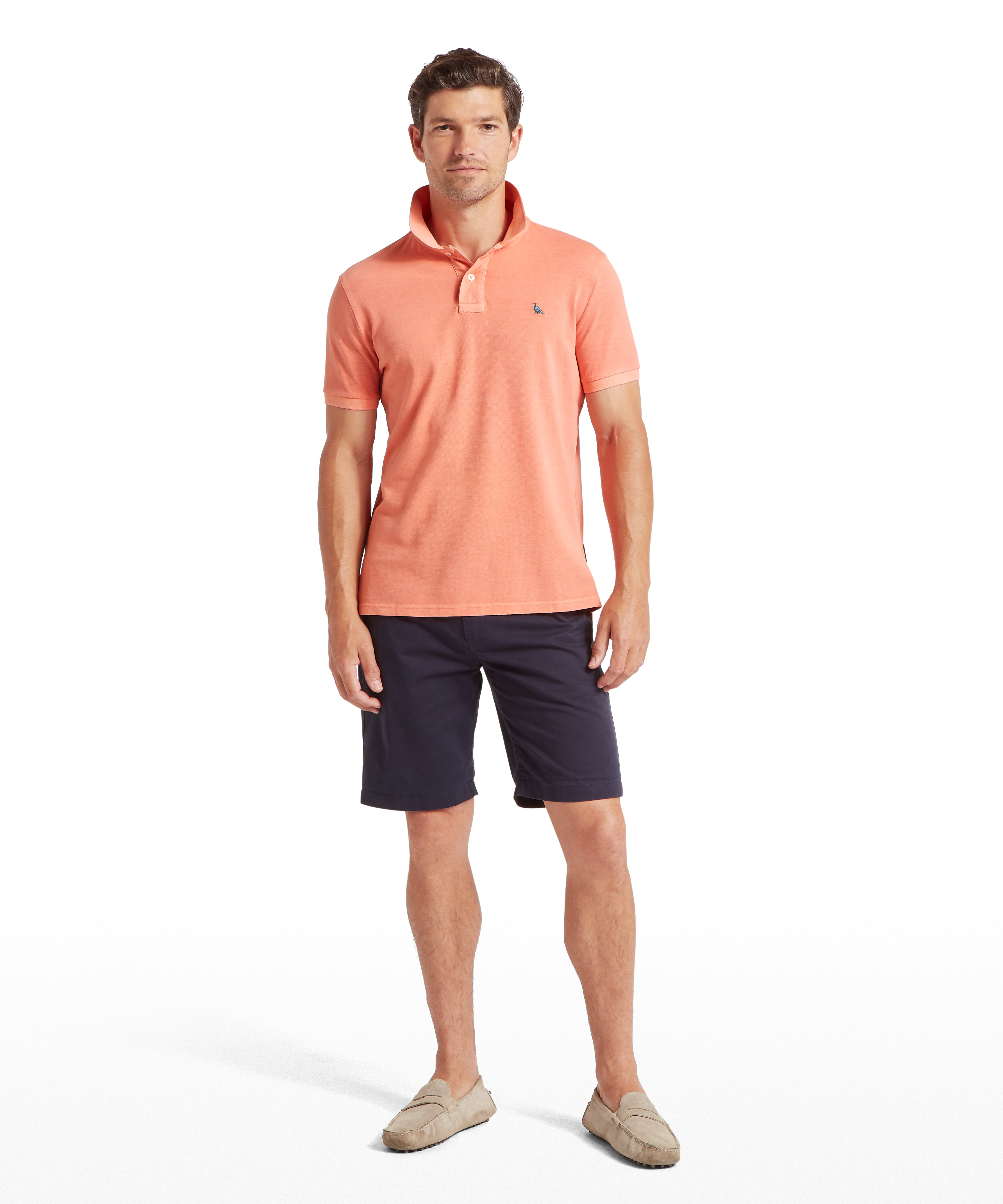 Schöffel's St Ives Garment Dyed Polo Shirt in Orange, on model, small embroidered logo on the chest