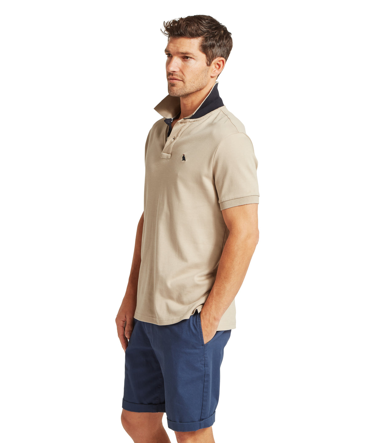 Beige St Ives jersey polo shirt with navy collar and sleeve trim featuring a small embroidered logo