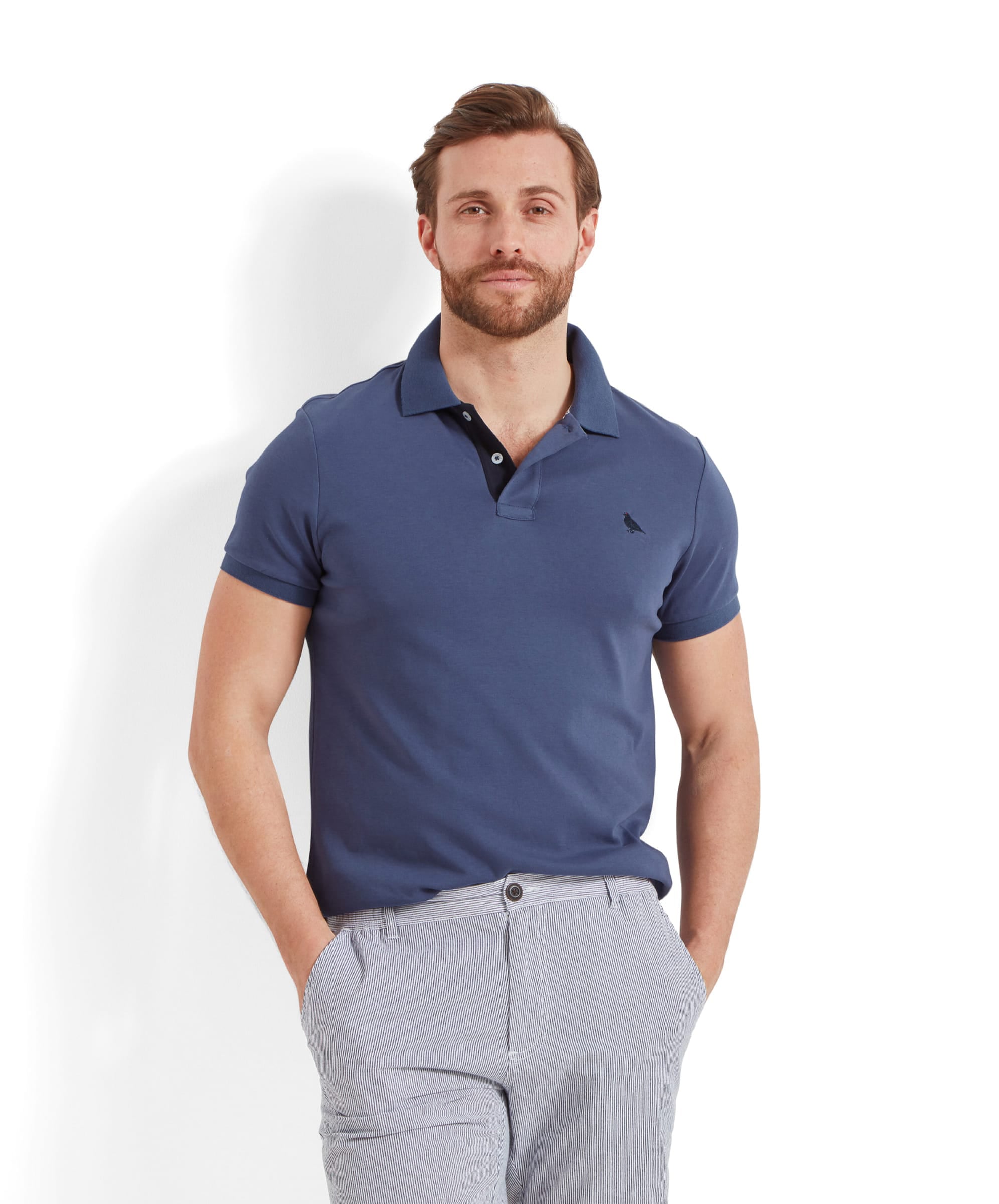 Schöffel Men's St Ives Jersey Polo Shirt in slate blue, worn by model styled with striped trousers
