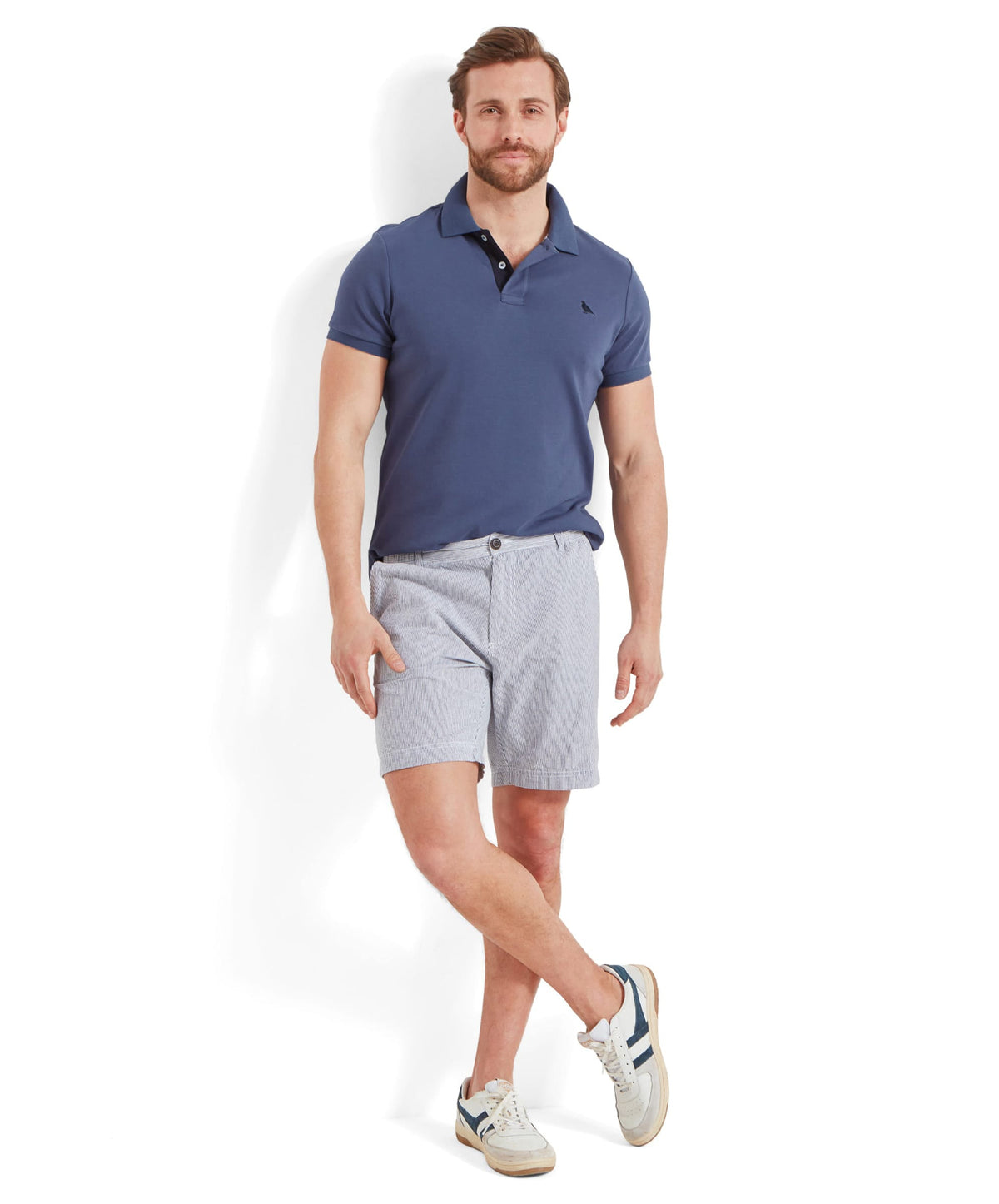 Man wearing St Ives jersey polo shirt in french navy with a small black logo and light gray