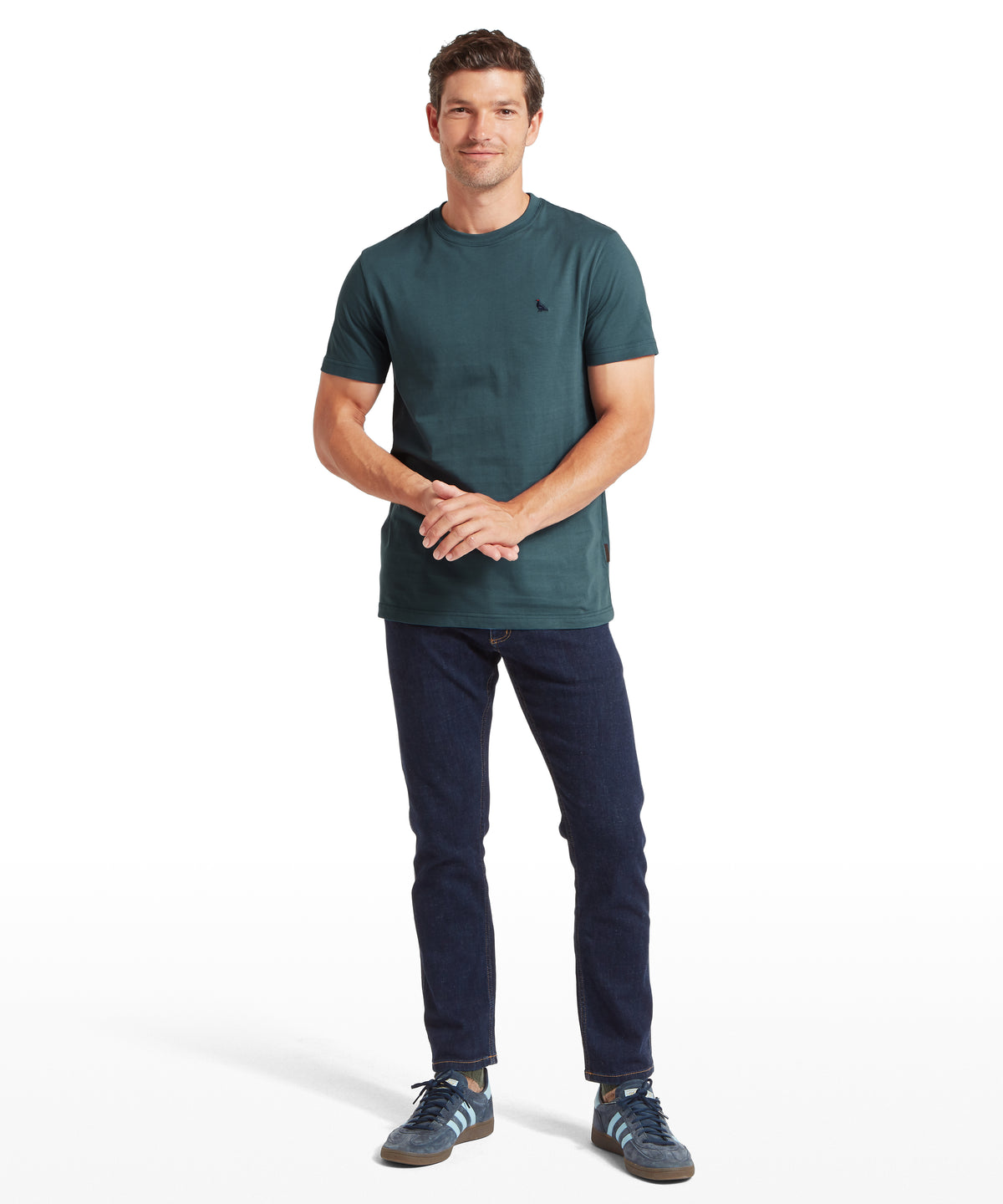 Dark teal crew neck trenance t shirt with small black bird logo on left chest in deep ocean blue