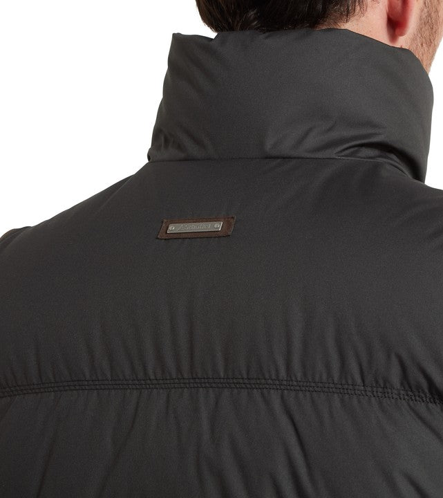 Rear neck close-up of the Schöffel Men's Twickenham II Gilet in dark grey, highlighting the suede-backed metal logo badge and high collar