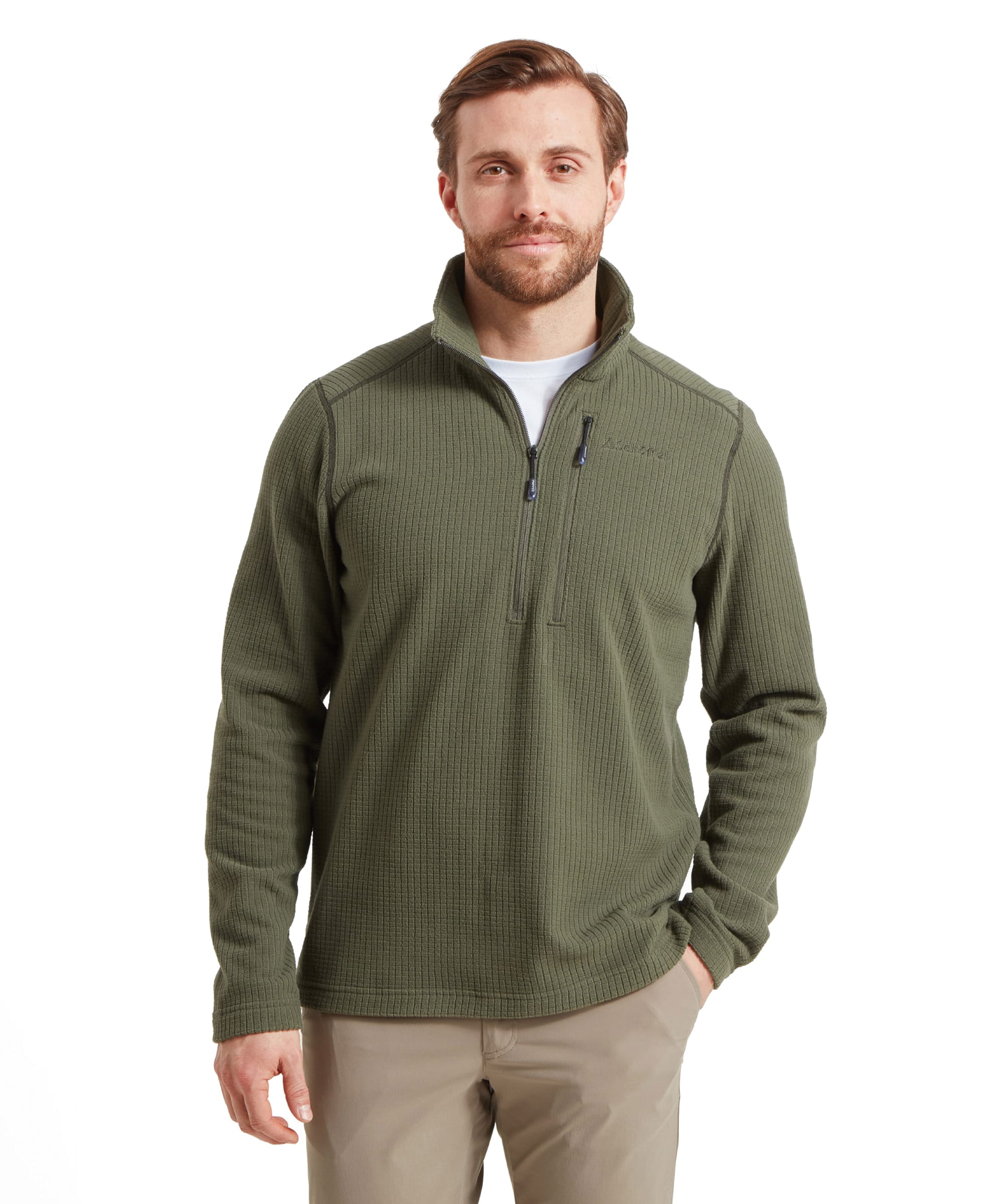 The model is wearing an Schöffel Welland Lightweight Fleece for Men in Green, also featuring a quarter-zip design. He pairs it with light beige trousers and a white undershirt, presenting a practical and outdoorsy look.
