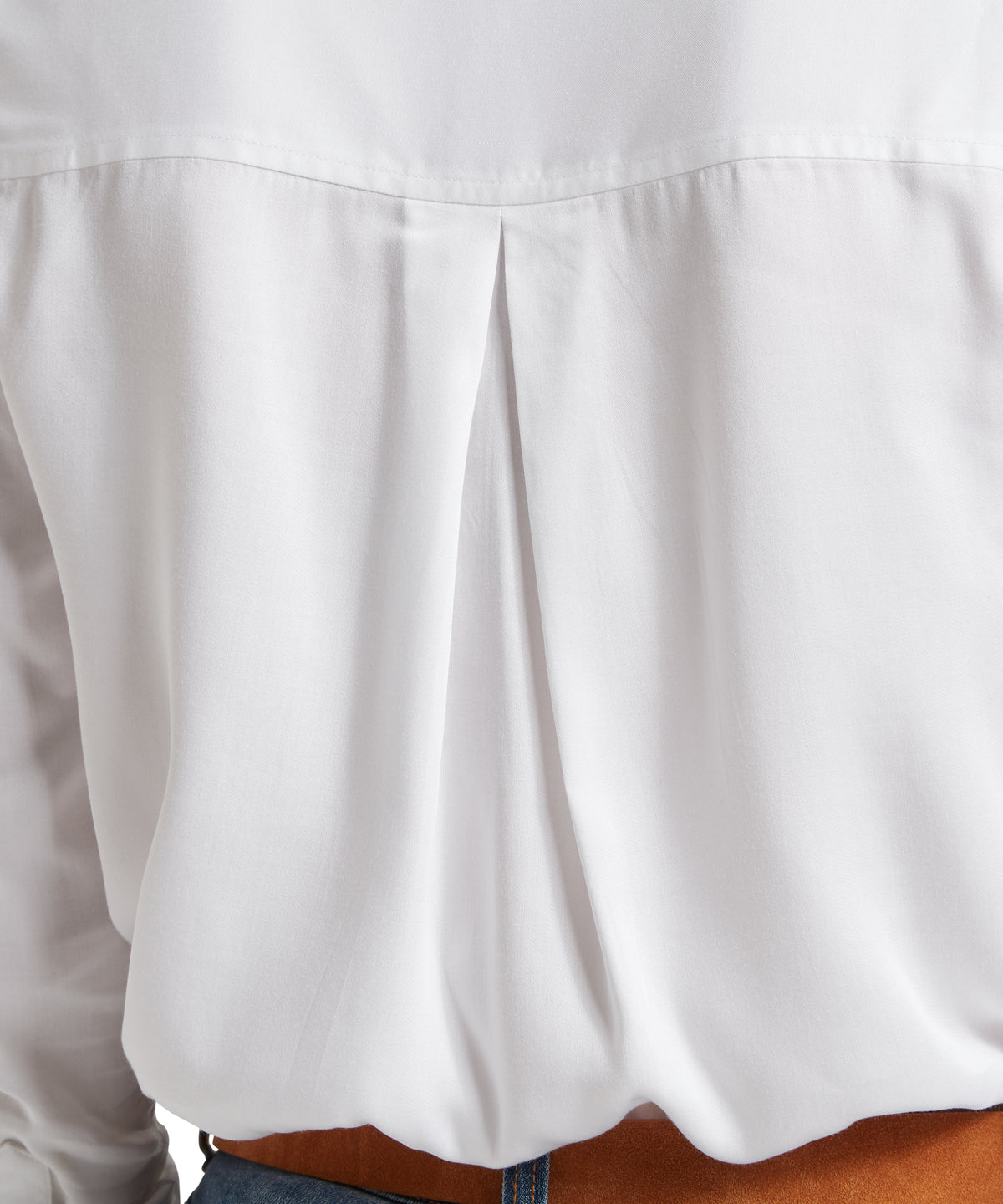 White alton blouse with soft flowing fabric and subtle pleats at the back showing elegant design