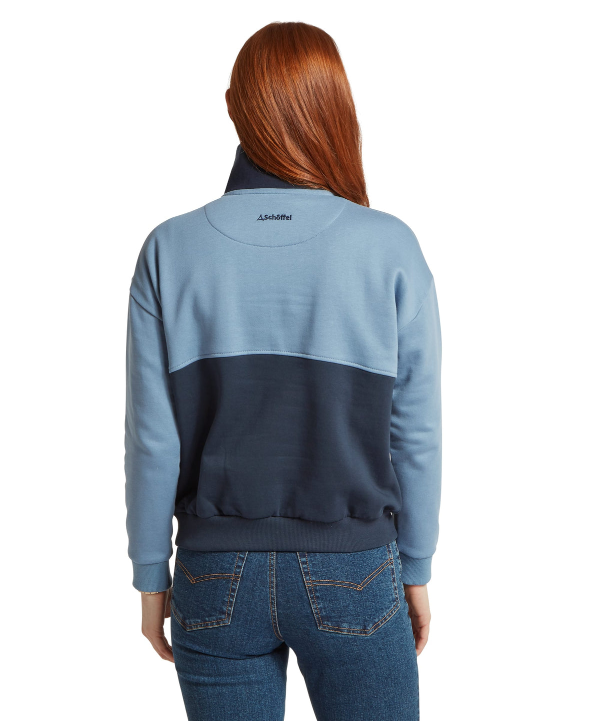 Schöffel's Braunton 1/4 Zip Sweatshirt in Blue, on model, worn with blue denim jeans