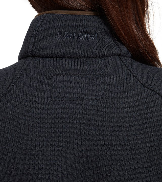 Close-up rear neck view of the Schöffel Women's Burley Hybrid Jacket in blue, showing the ribbed knit collar and embroidered Schöffel logo