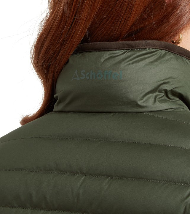Green puffer jacket with a visible Schöffel brand logo on a white background