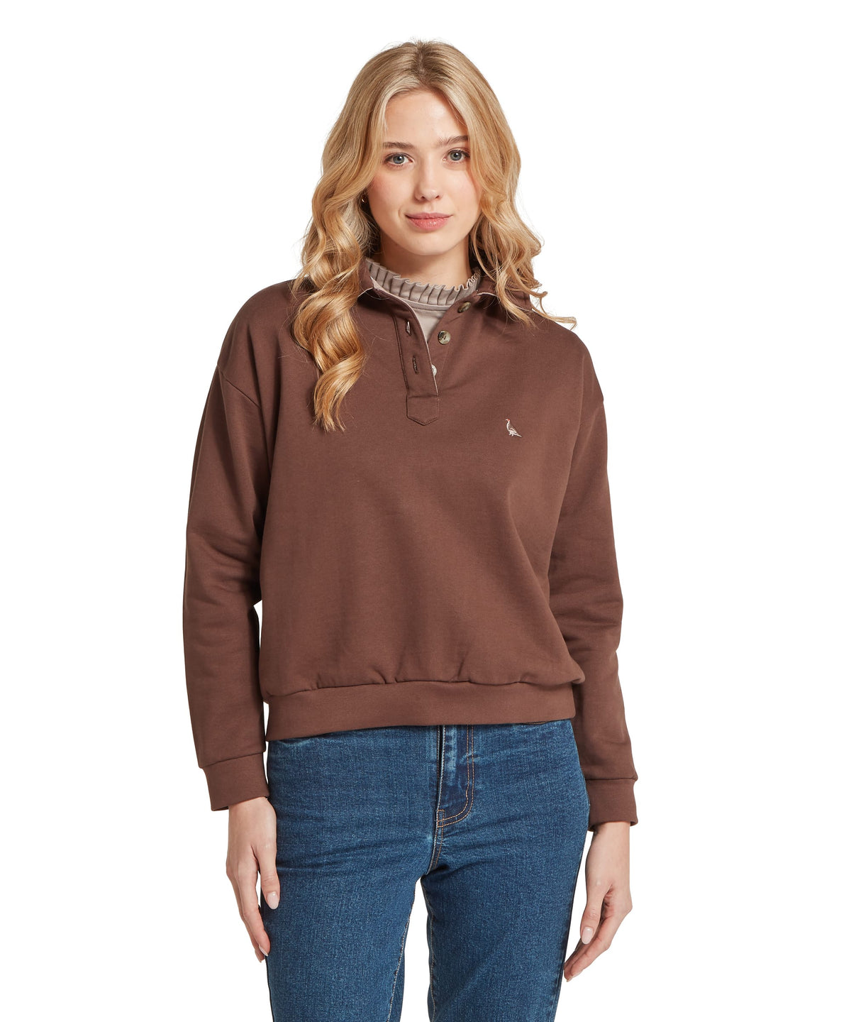 Model wearing the Schöffel Horseley Rugby Sweatshirt in Brown, embroidered bird logo