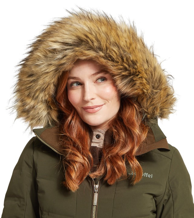 Schöffel Hurlingham women's waterproof down coat in green, close-up of woman wearing faux fur-trimmed hood with contrast collar and embroidered logo