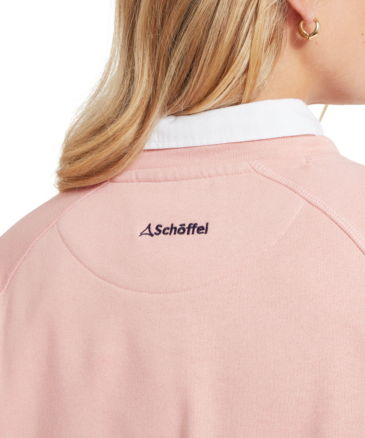 Pink schöffel polo shirt with white collar and black embroidered logo featured in newberry