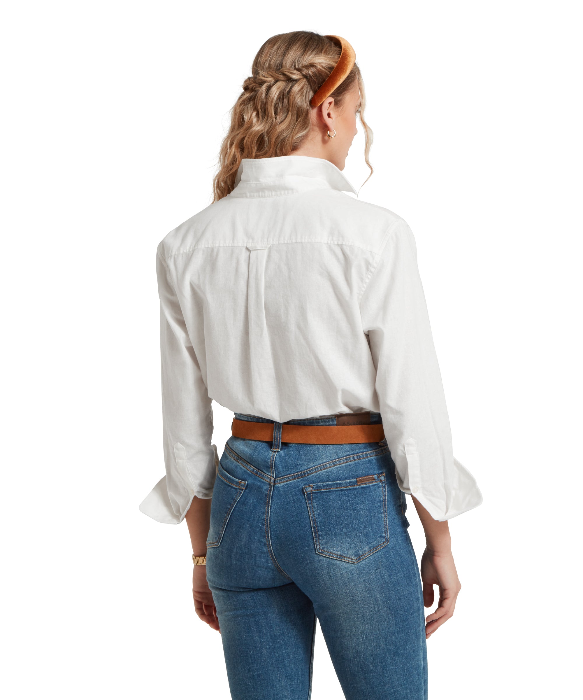 Back image of a female model wearing a tucked in white linen Schöffel shirt, paired with mid denim jeans and tan leather belt. She is standing in a relaxed pose with her hands by her side.