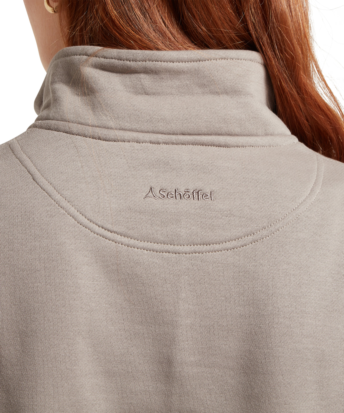 A soft heathered gray schöffel fleece pullover with high collar and subtle embroidered branding