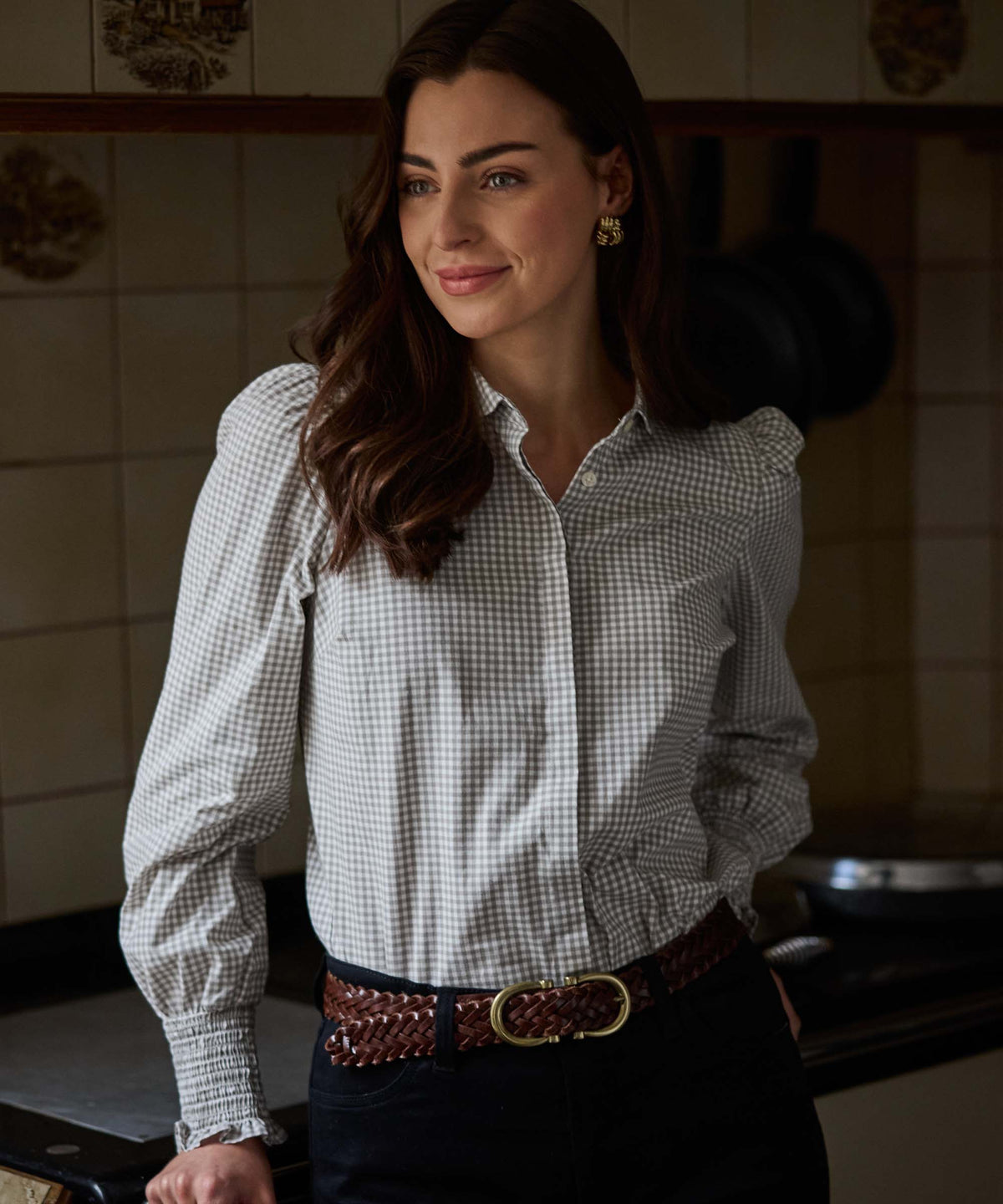 Woman wearing sage green flora gingham shirt with puffed sleeves and smocked cuffs in crisp white