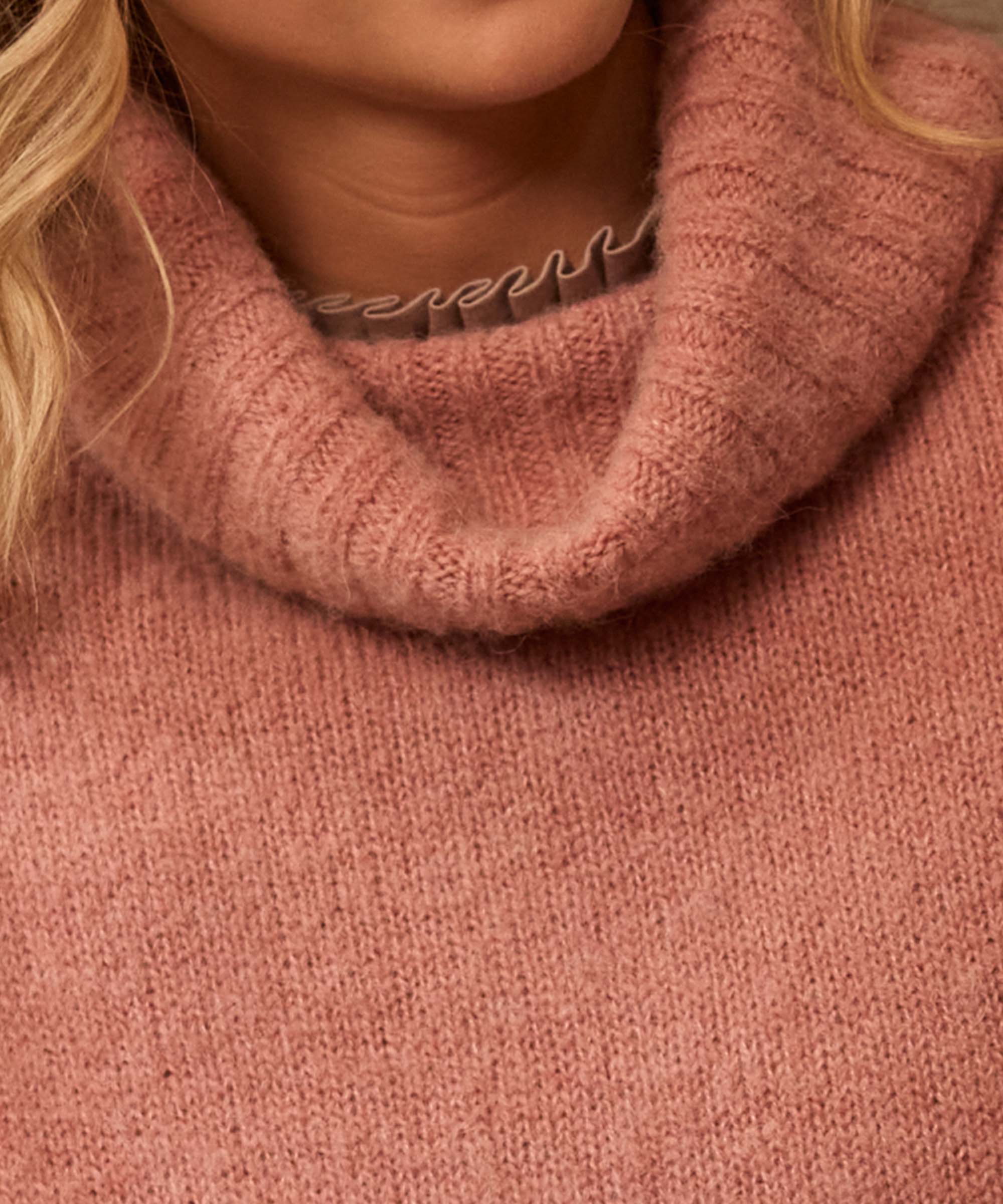 Detail shot of the ribbed cowl neck on a dusky pink knitted jumper, worn with gold hoop earrings for a country-chic finish