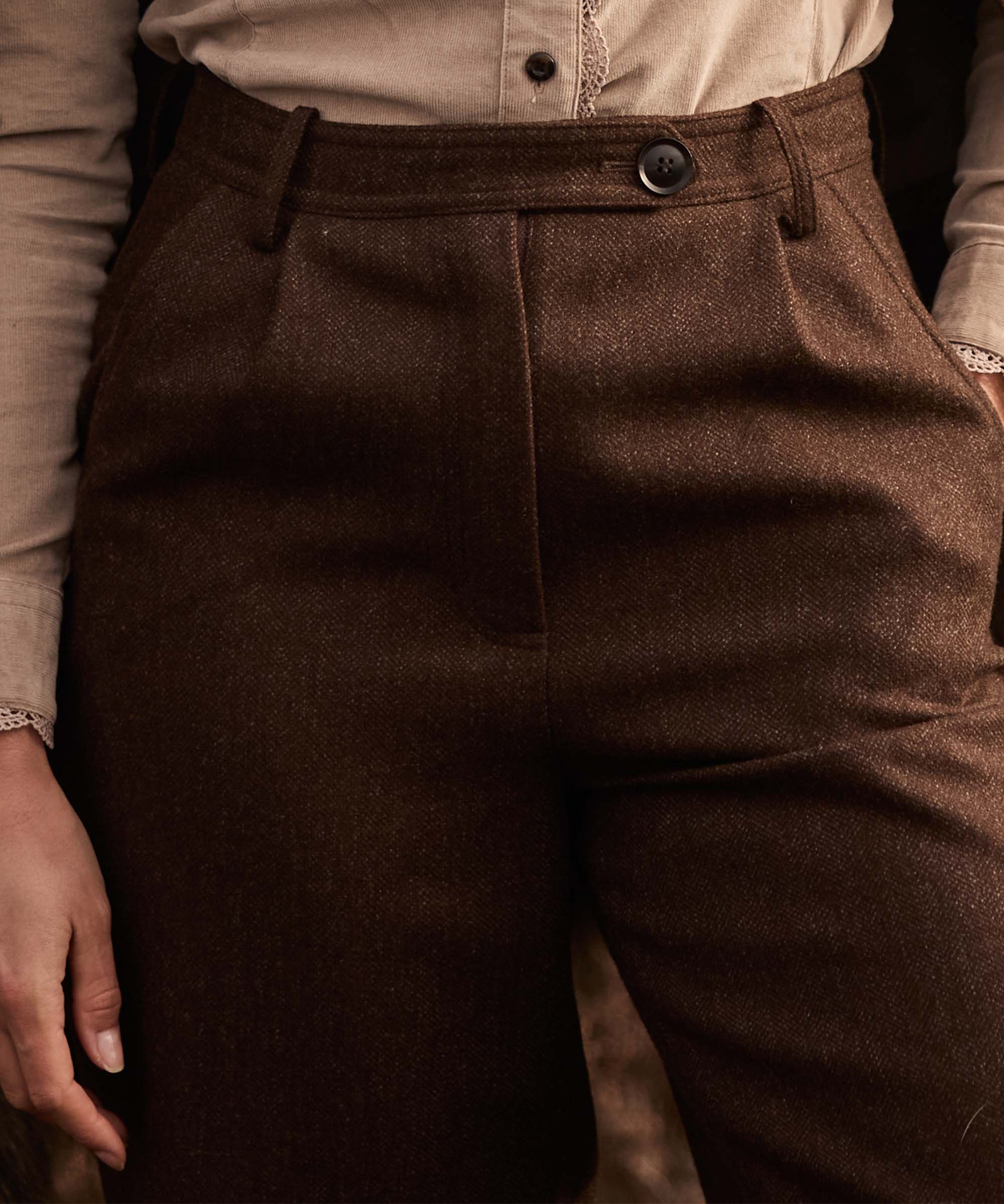 Close-up of the waistband and button fastening on Schöffel Country's brown herringbone tweed trousers