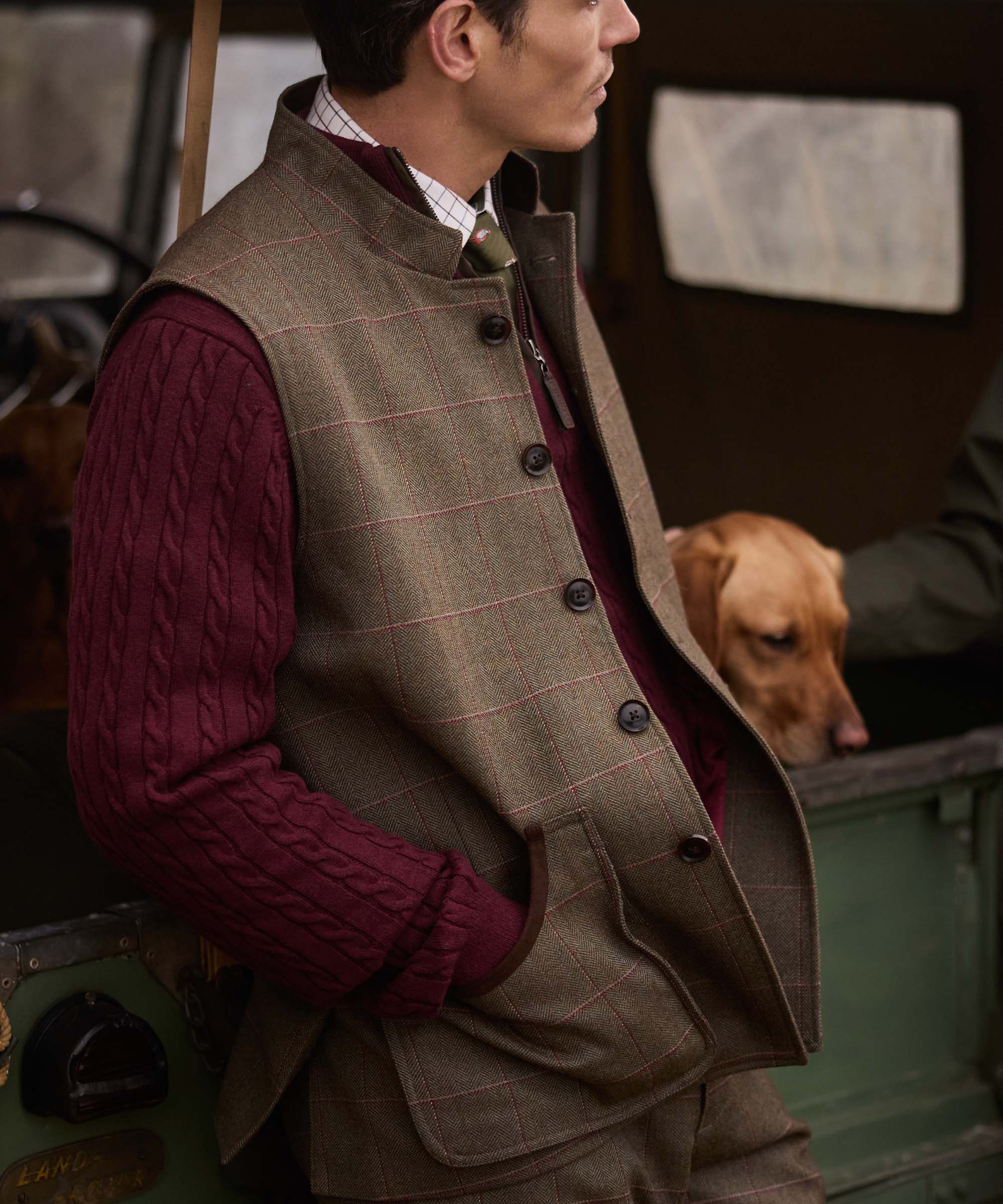 Close-up of woman wearing Schöffel Country's tweed gilet with button fastening, styled with a burgundy jumper