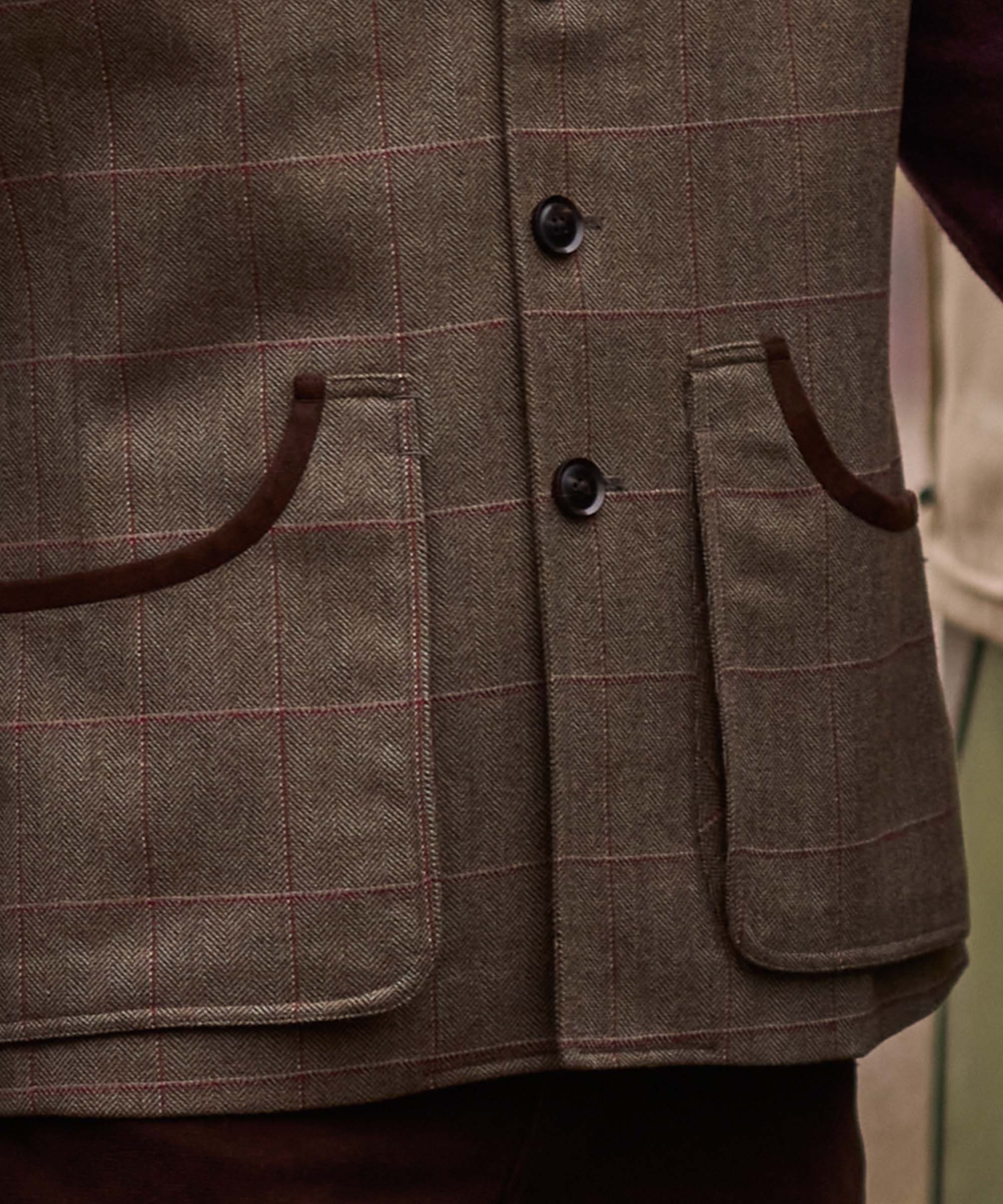 Close-up of the bellows pockets and button fastening on Schöffel Country's tweed gilet