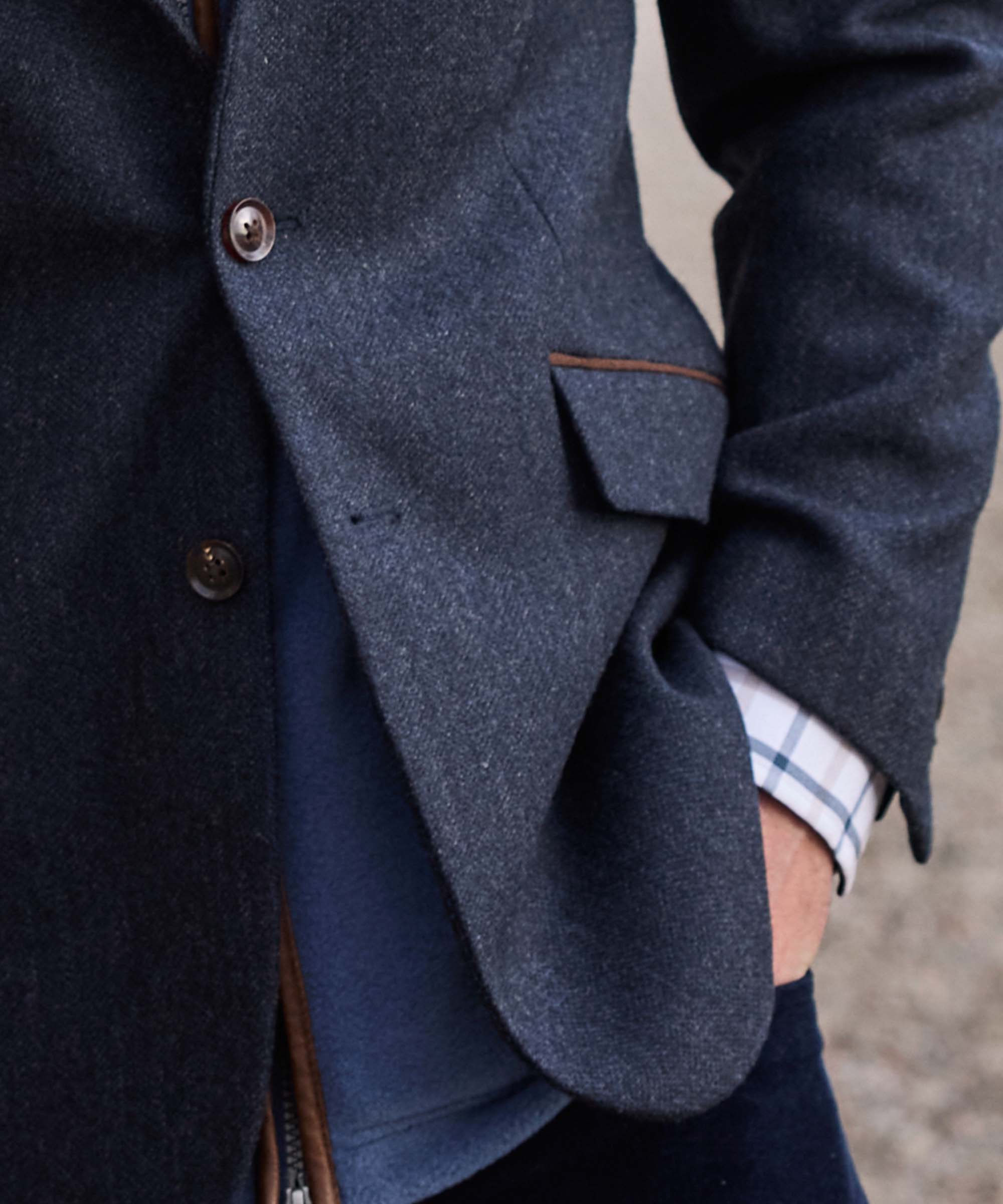 Close-up of the flap pocket and leather trim detail on Schöffel Country's navy herringbone tweed blazer