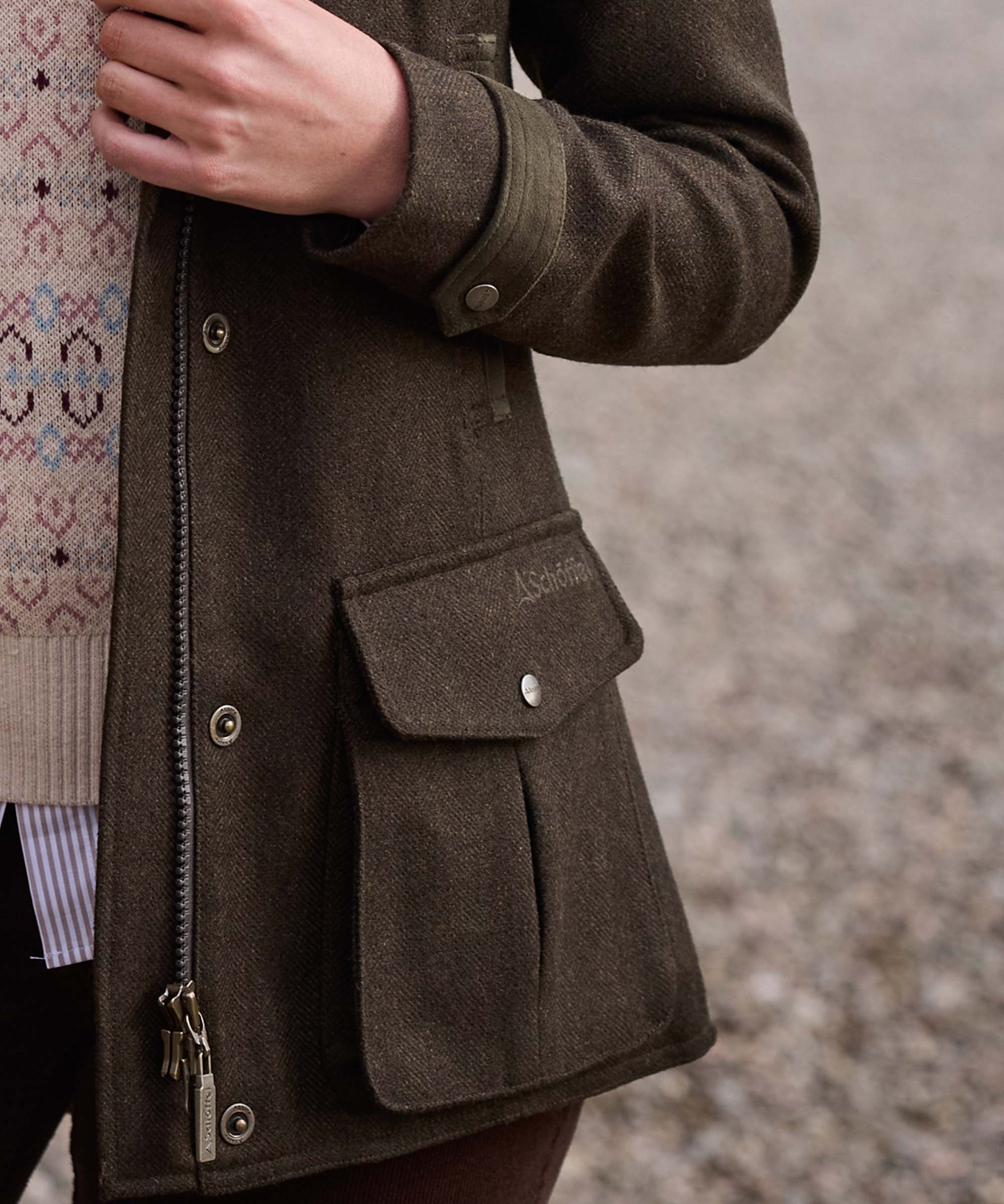 Close-up of the cuff and flap pocket detail on Schöffel Country's khaki wool field coat
