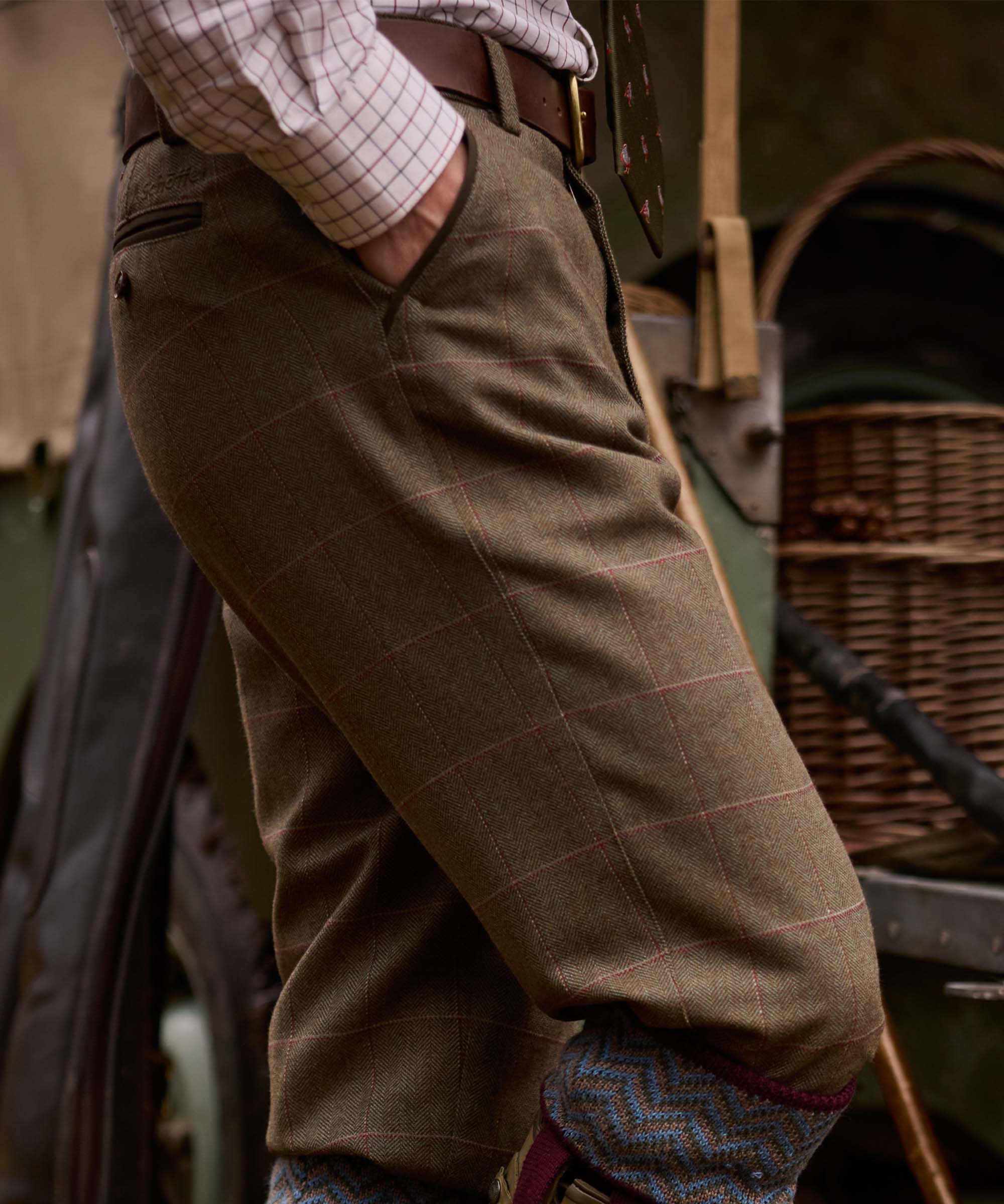 Close-up of the side pocket detail on Schöffel Country's herringbone tweed trousers, worn with patterned socks