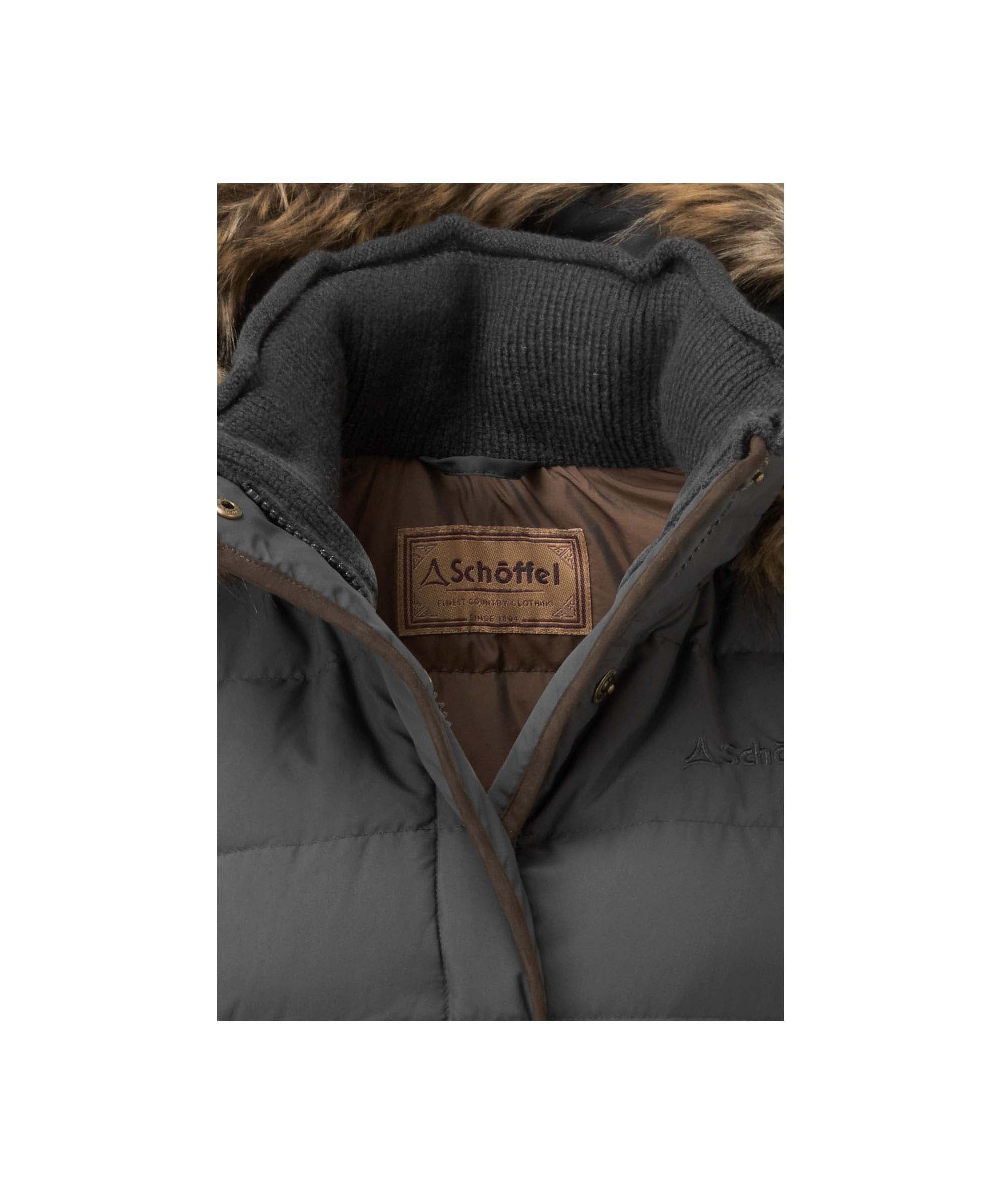 Schöffel Women's Down Jacket in Charcoal close-up showing fur-trim hood, knit inner collar and branded heritage label detail