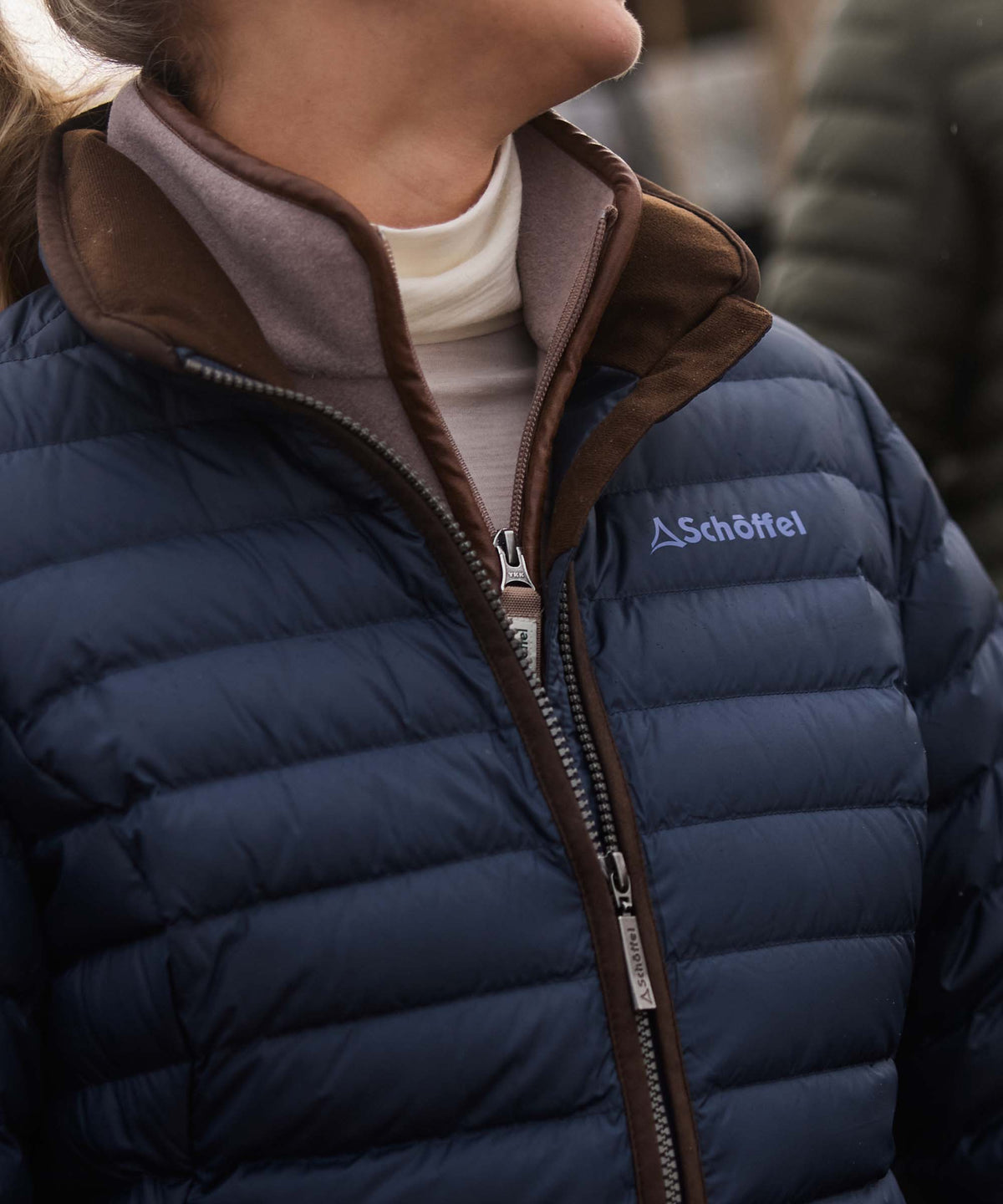 Navy blue quilted puffer hambleton down jacket with brown trim and schöffel logo on the chest