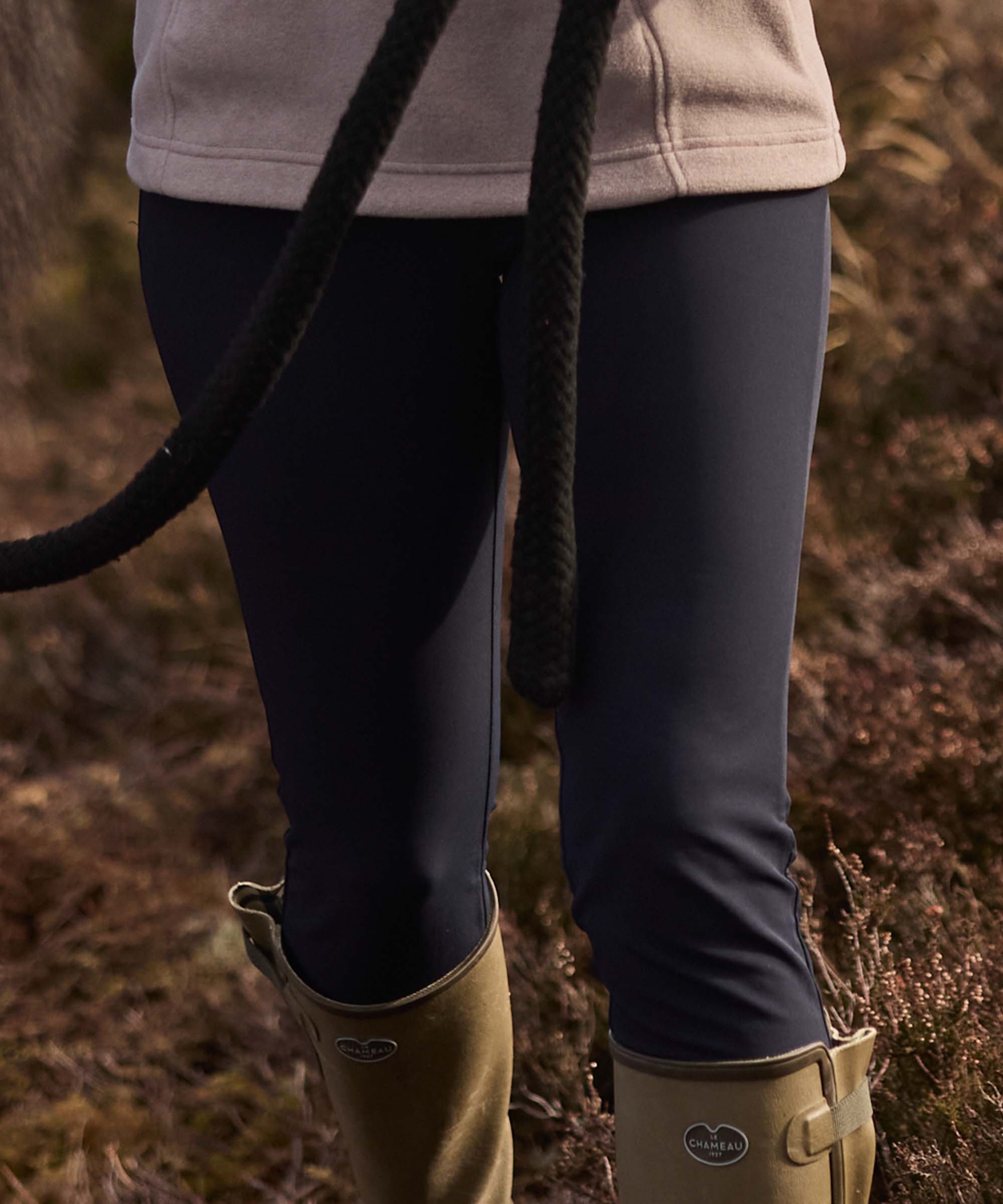 Close-up of a person outdoors wearing dark navy trousers.
