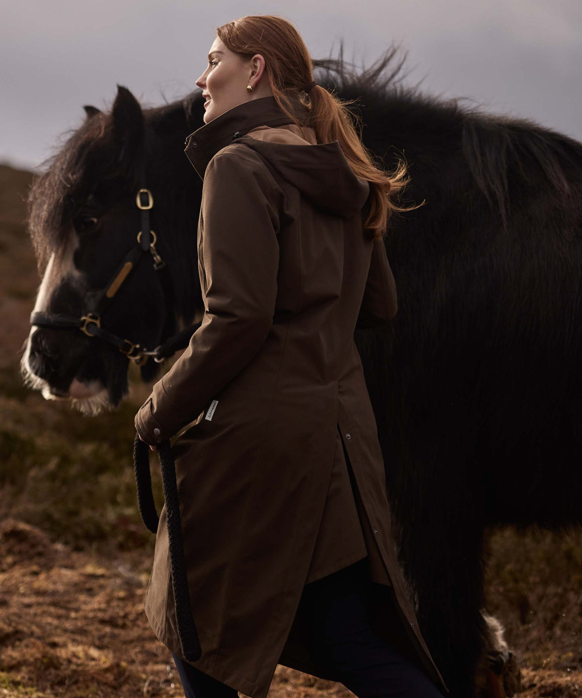 Brown marefield waterproof riding coat with hood and adjustable cuffs in dark caper shown from