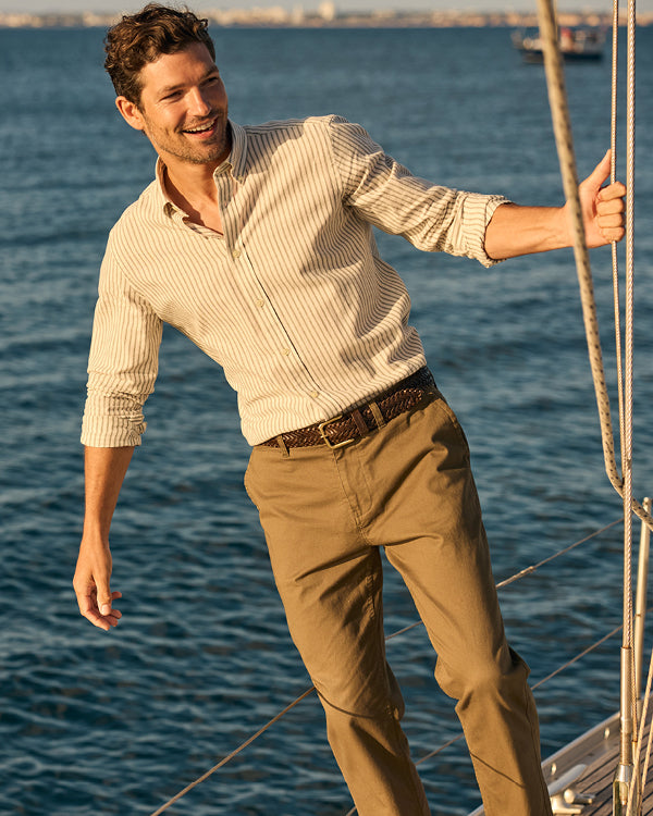 Man on a sailboat with water in the background