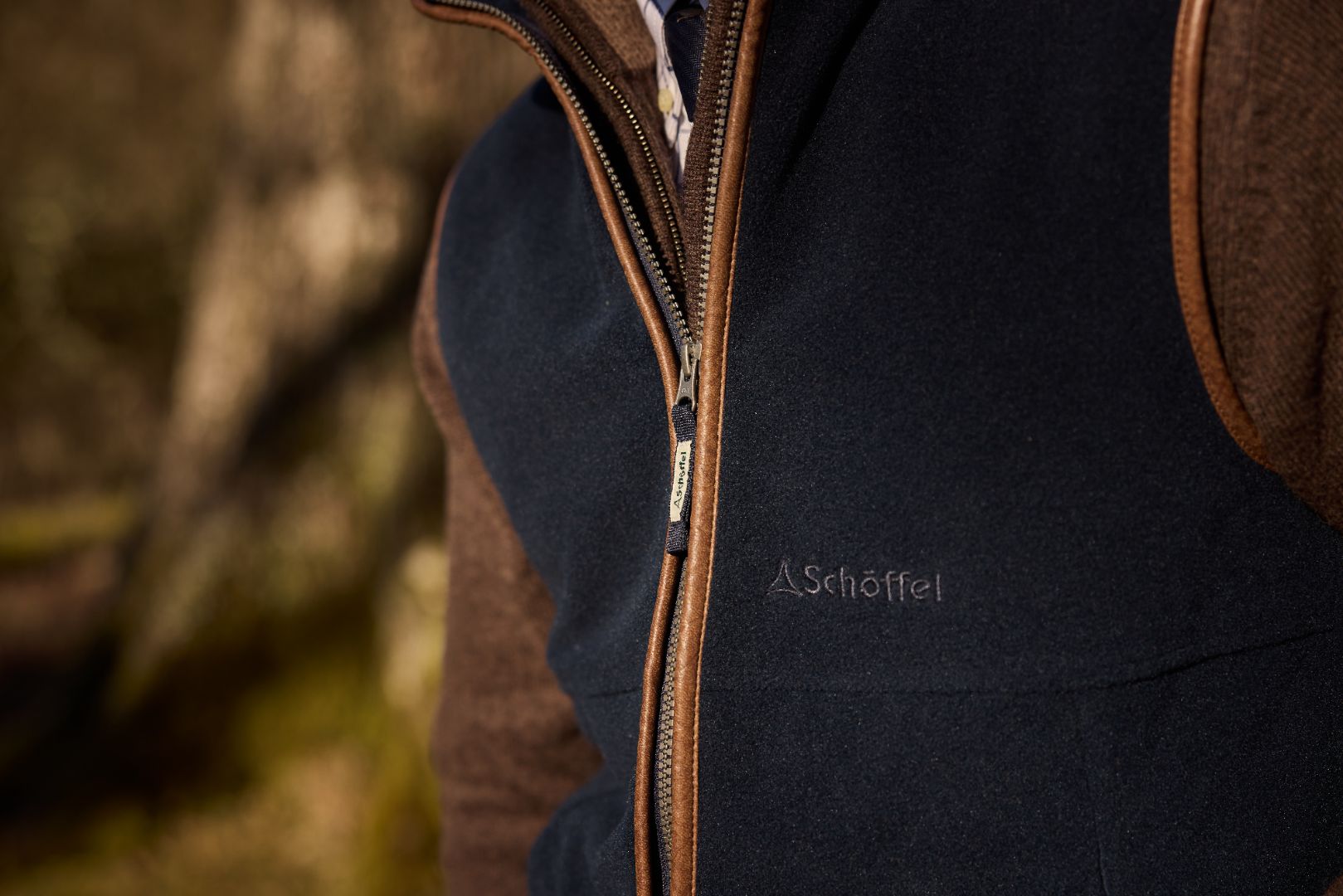 Close up of a navy Schöffel Oakham gilet over a brown jumper