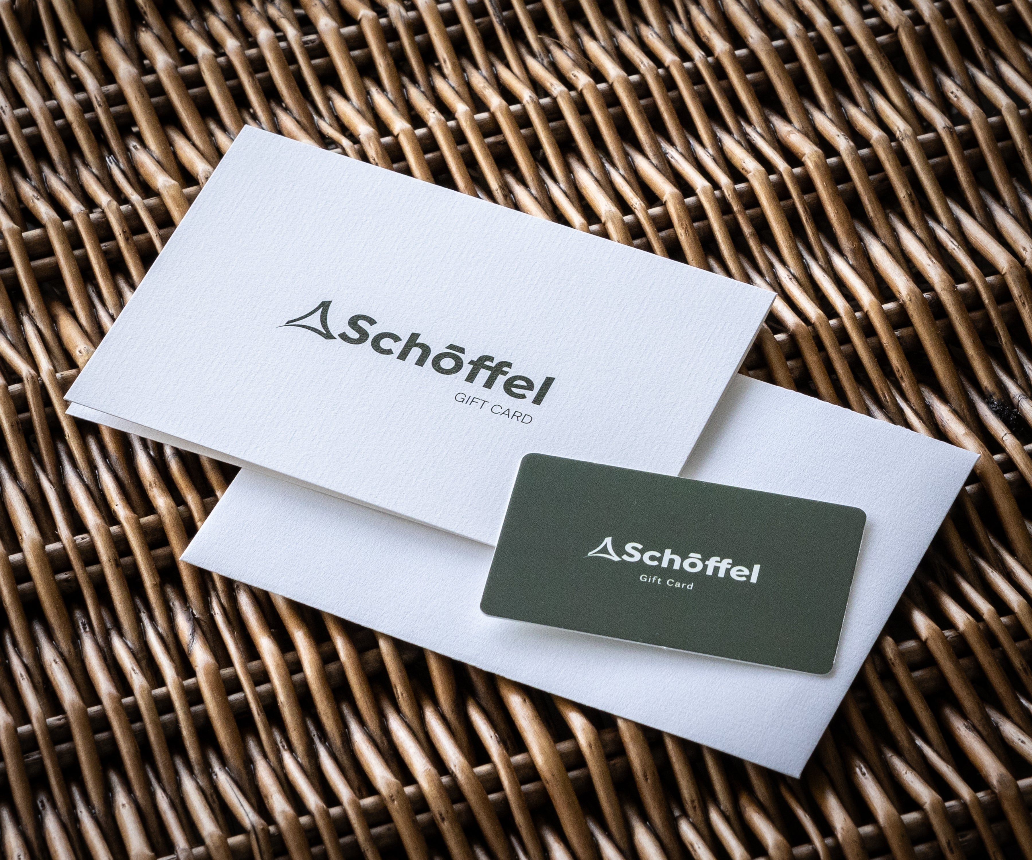 Schöffel gift card on a white envelope with Schöffel logo on a wicker surface