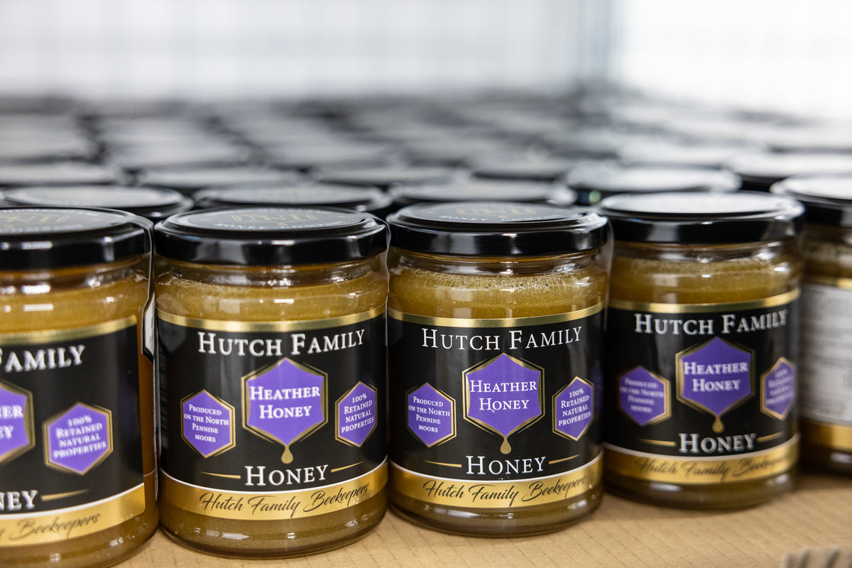 Row of honey in a line with the name "Hutch Family Honey" printed on the front.