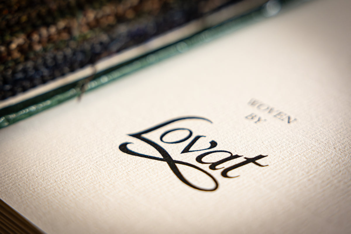 Close-up of a cream-colored  surface with the brand name 'Lovat' printed in black script
