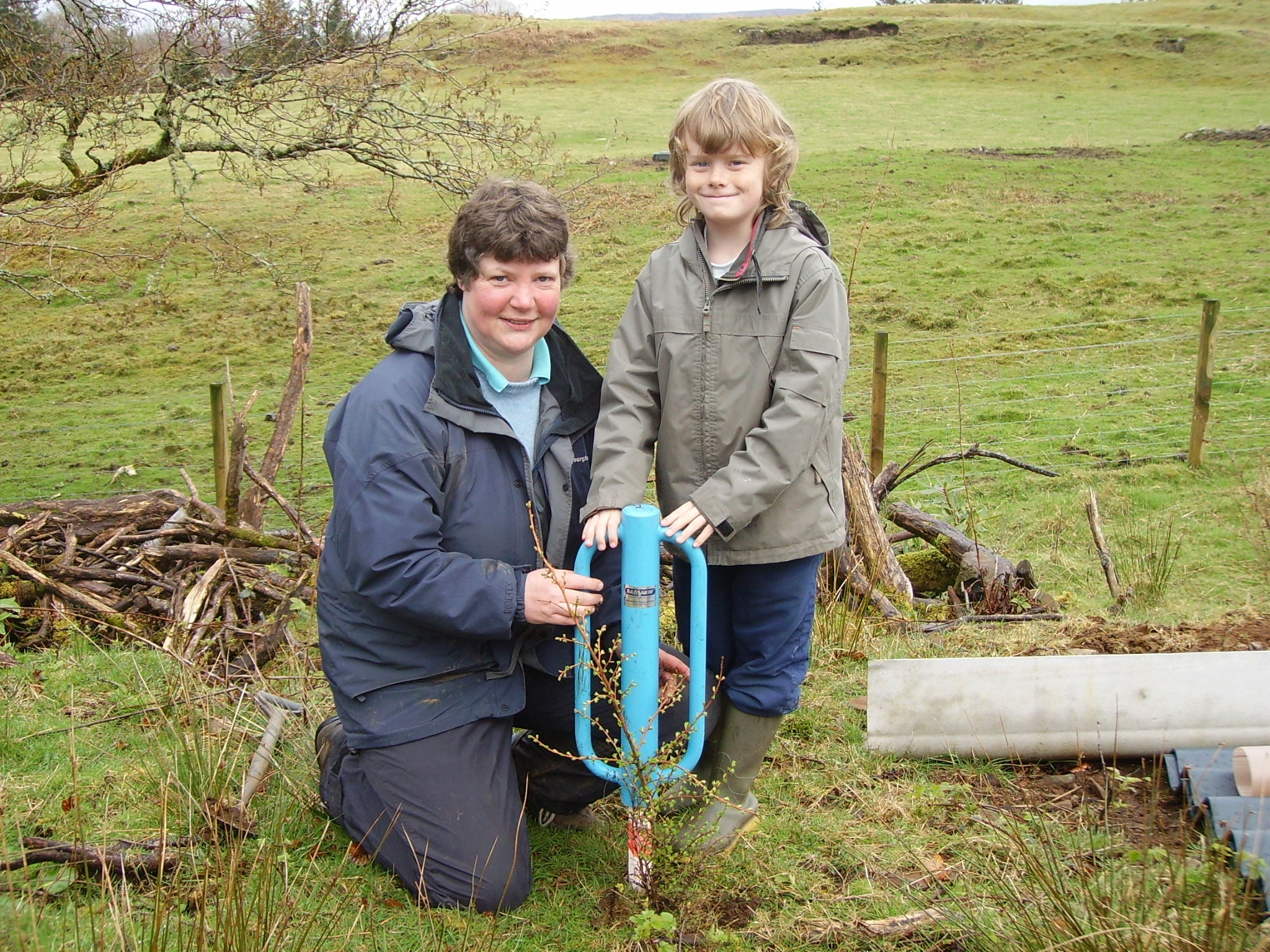 A young Tom Hilder planting a tree