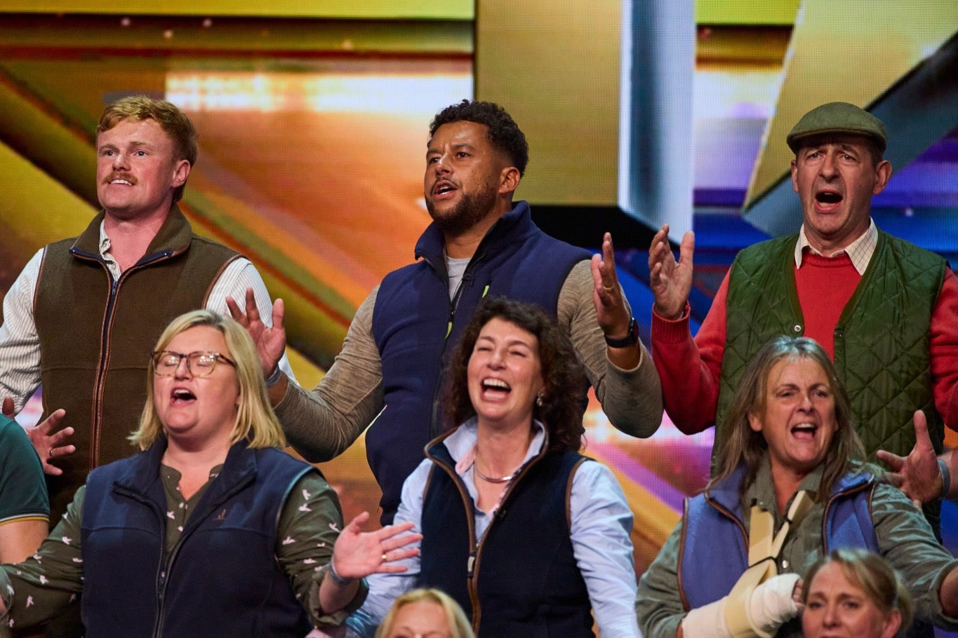 Group of people reacting with surprise or excitement against a colorful studio background