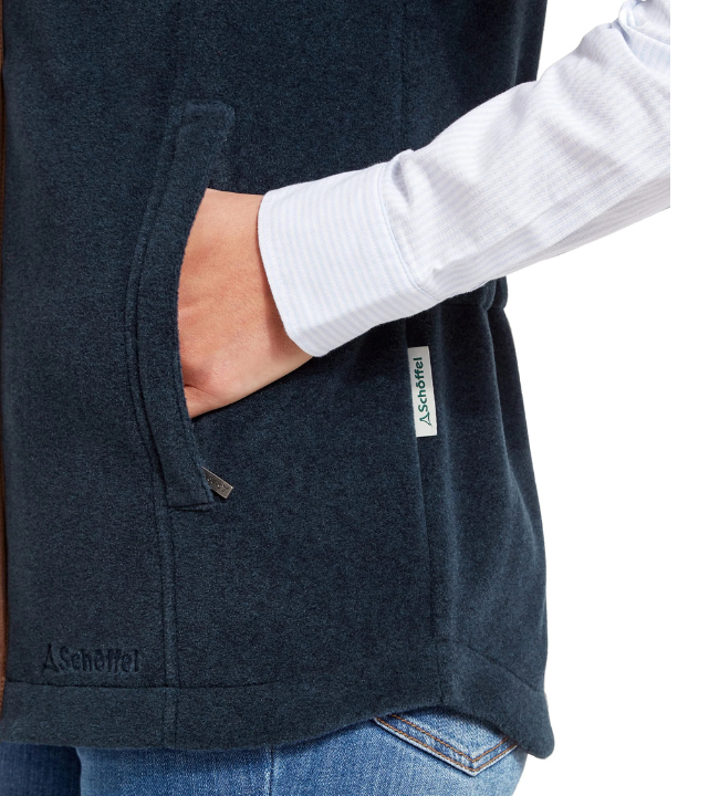 Close up of Navy fleece jacket focussing on the pocket area.  Across the side seem there is a label with a Schöffel logo on.