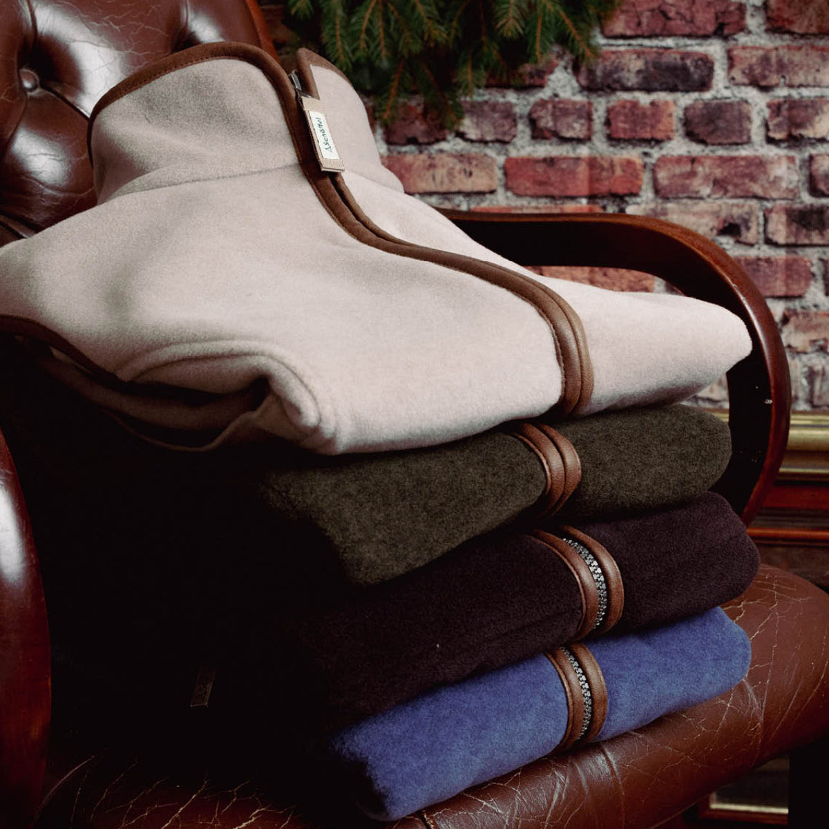 Folded oatmeal zip neck jumper presented on festive wrapped gifts