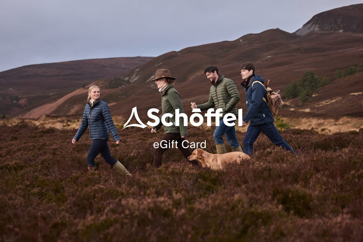 Schöffel egift card logo with white triangular emblem and text on a natural outdoor background for gifting