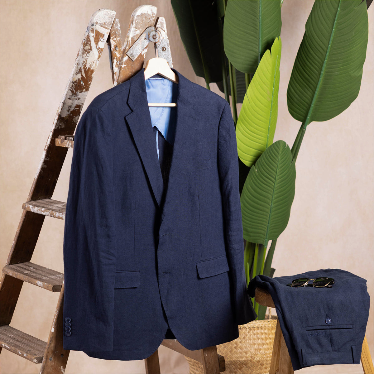 Blue linen suit jacket hanging on a aesthetic ladder.