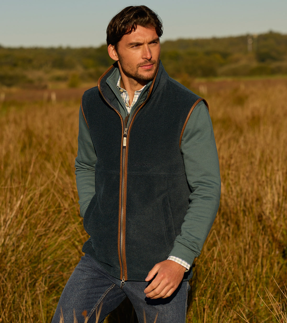Man wearing a green fleece vest in a field
