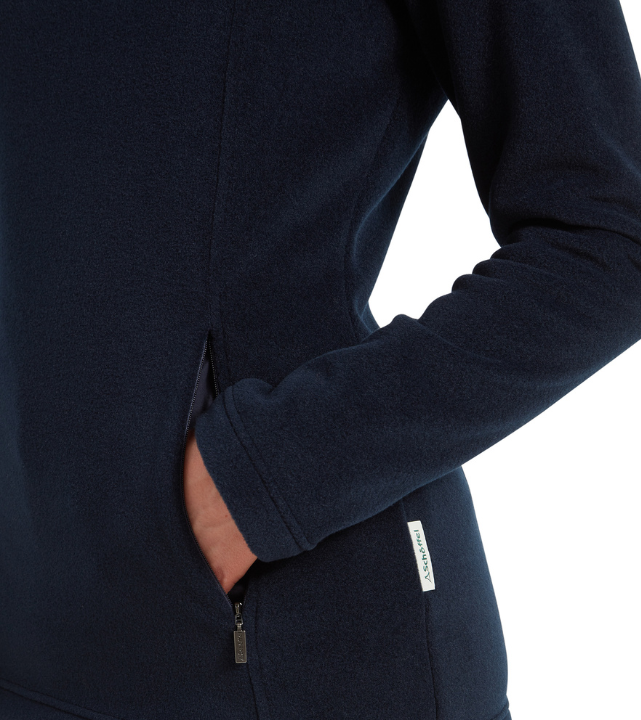 Close-up of a navy quarter‑zip fleece showing side pocket detail, zip fastening and Schöffel branded label.