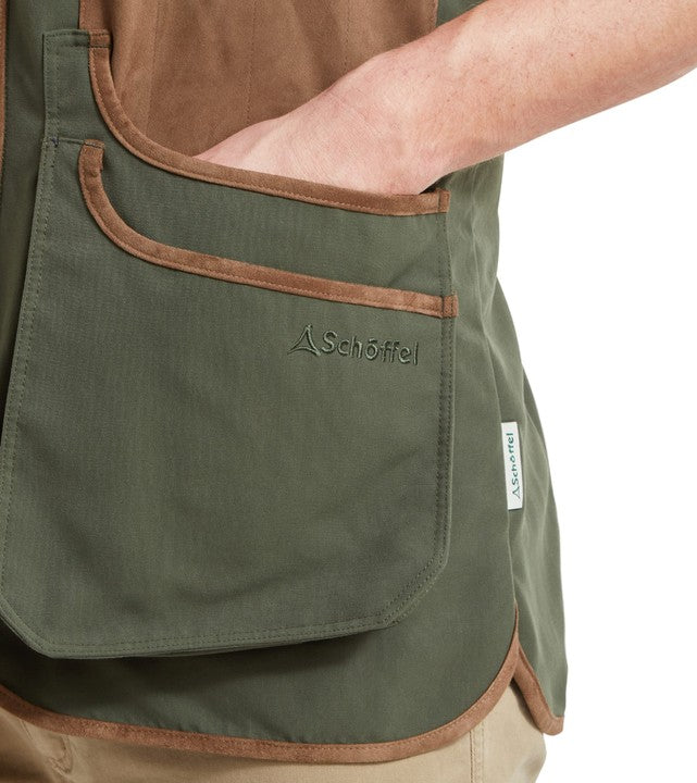 Detail of Schöffel Men's Grimsthorpe Clay Shooting Vest in forest green, showing the large double bellows cartridge pocket, suede trim edging and Schöffel logo