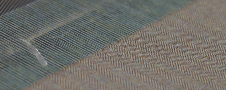 An video showing the warping and weaving process of making tweed.