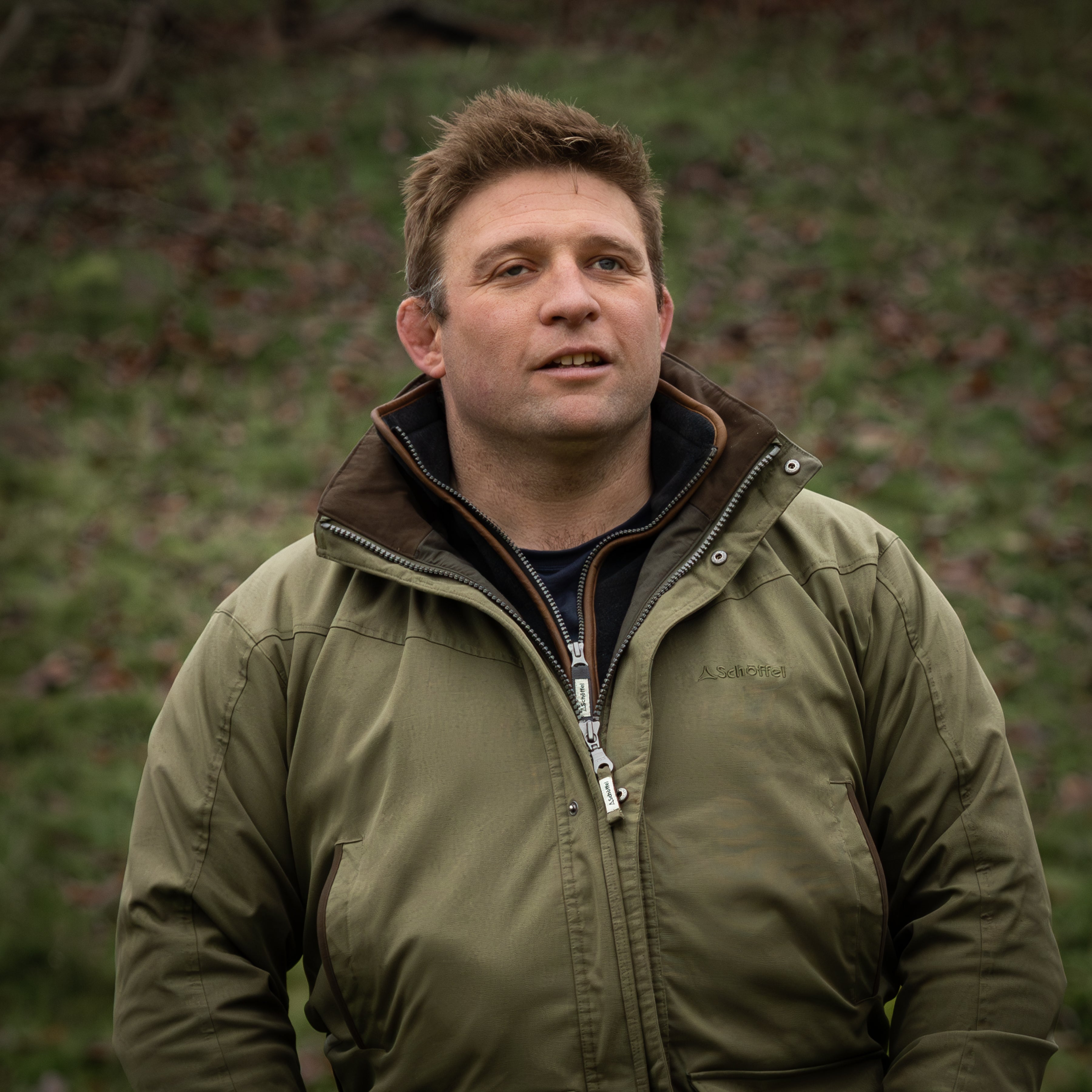 Tom Young wearing a green jacket over a blue gilet