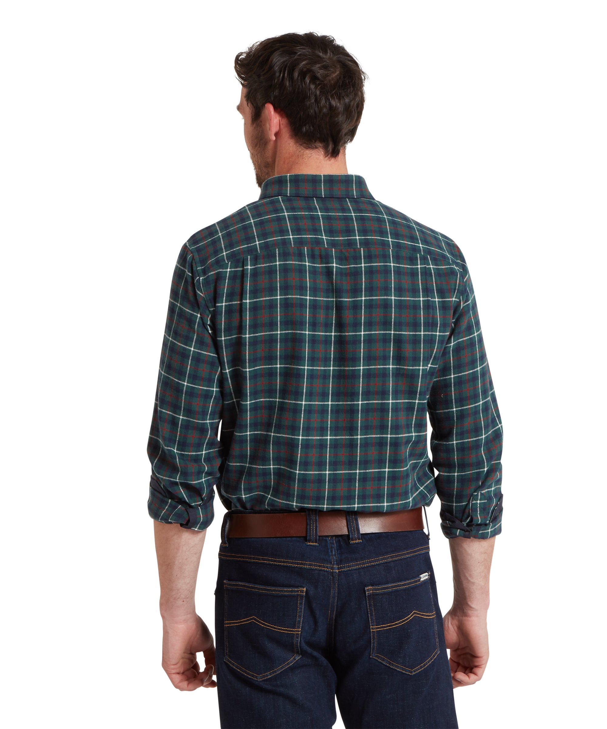 Man wearing a green plaid shirt and dark jeans on a white background