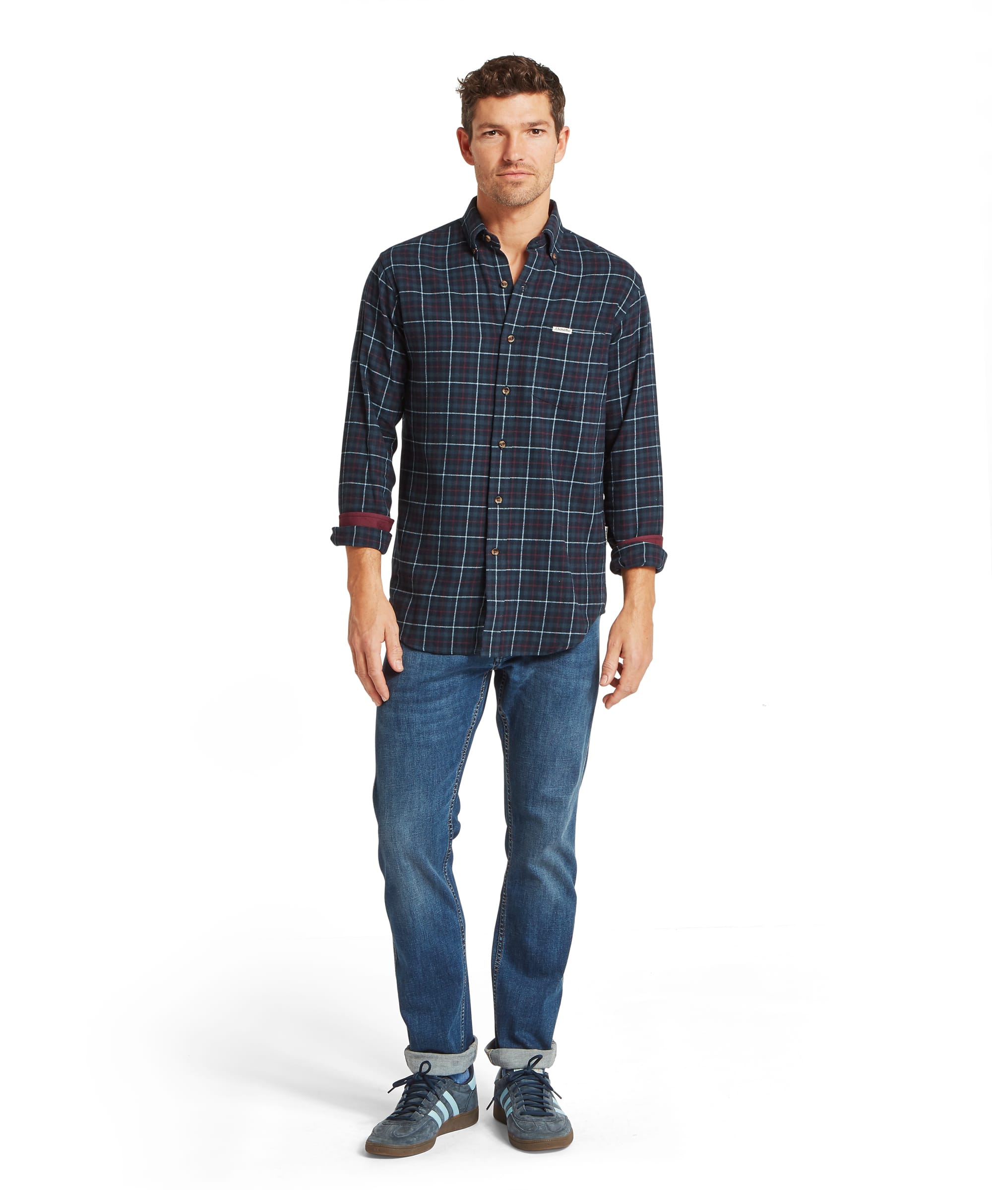 Schöffel Men's Akenham Shirt in Blue - rear view showing the deep navy tartan check with burgundy and white overcheck, back pleat, and rolled burgundy wax cotton cuffs, worn with blue jeans.