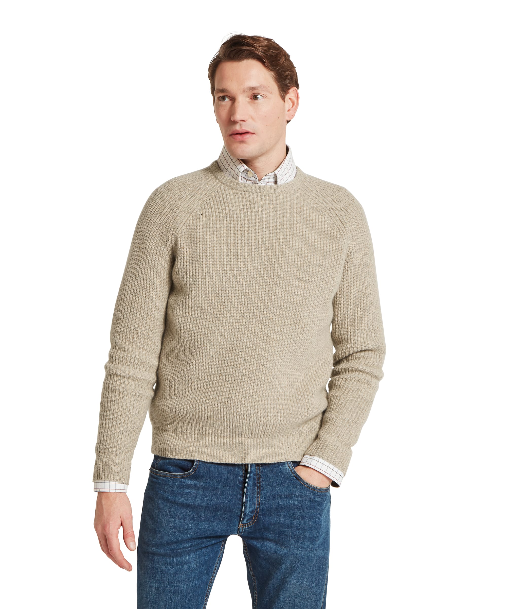 Schöffel Men's Balmaha Crew Neck Jumper in Beige - three-quarter front view of a chunky ribbed oatmeal lambswool crew neck jumper with raglan sleeves, layered over the Baconsthorpe Tailored Shirt, worn with blue jeans.