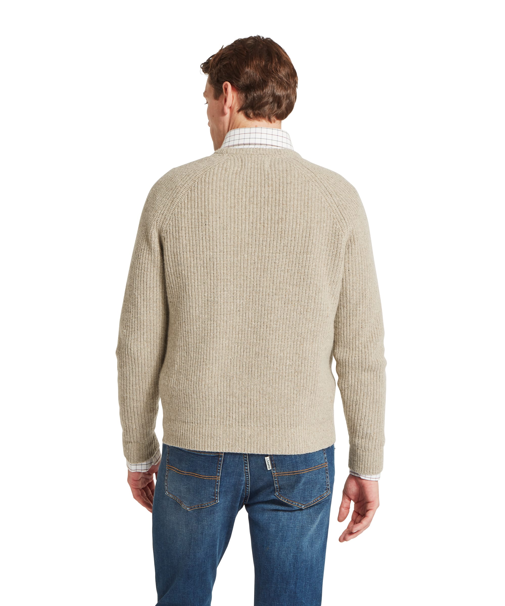 Schöffel Men's Balmaha Crew Neck Jumper in Beige - rear view showing the ribbed back panel and raglan shoulder seams of the oatmeal lambswool crew neck jumper, worn over a check shirt with blue jeans.