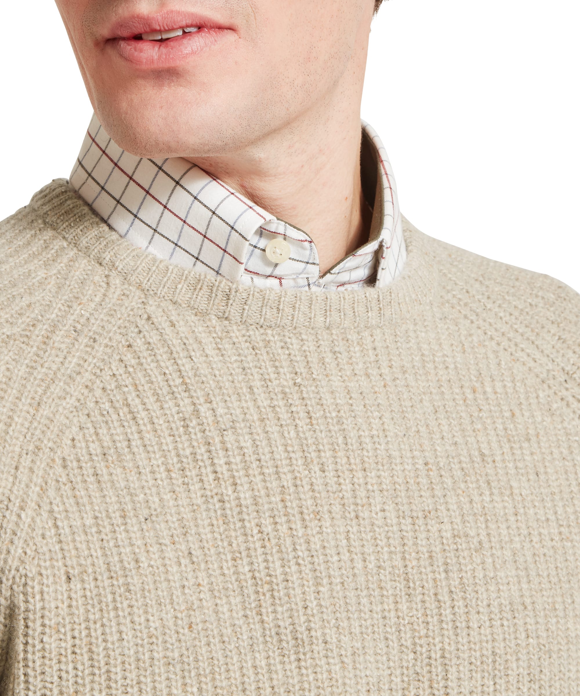 Close-up collar and neckline detail of the Schöffel Men's Balmaha Crew Neck Jumper in Beige, showing the chunky ribbed oatmeal lambswool texture and the layered check shirt collar peeking above the crew neck.